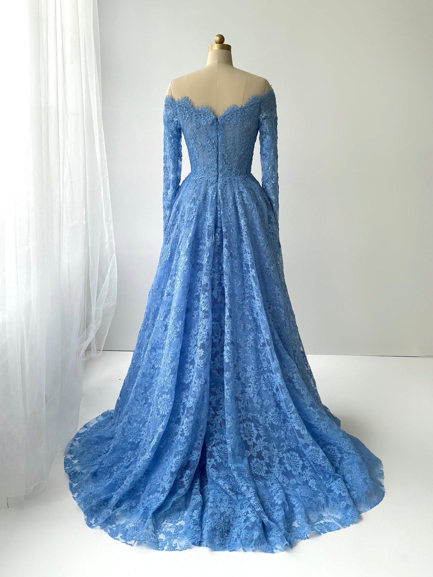 Blue A-Line gown with long off the shoulder sleeves and lace