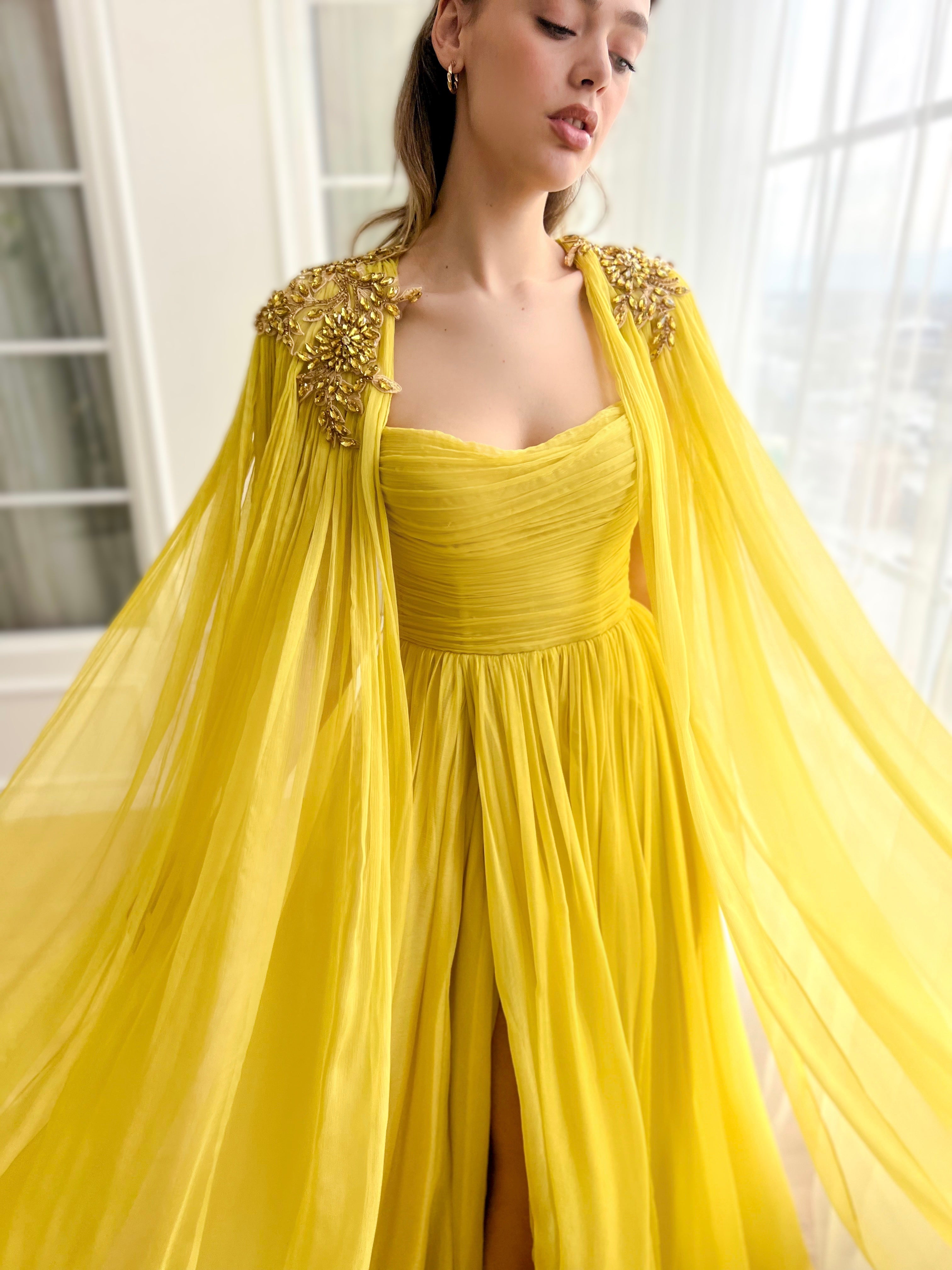 Yellow A-Line dress with embroidery and cape sleeves