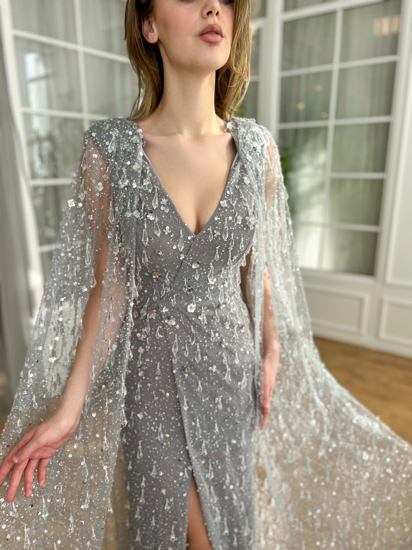 Grey mermaid dress with v-neck, cape and embroidered crystals