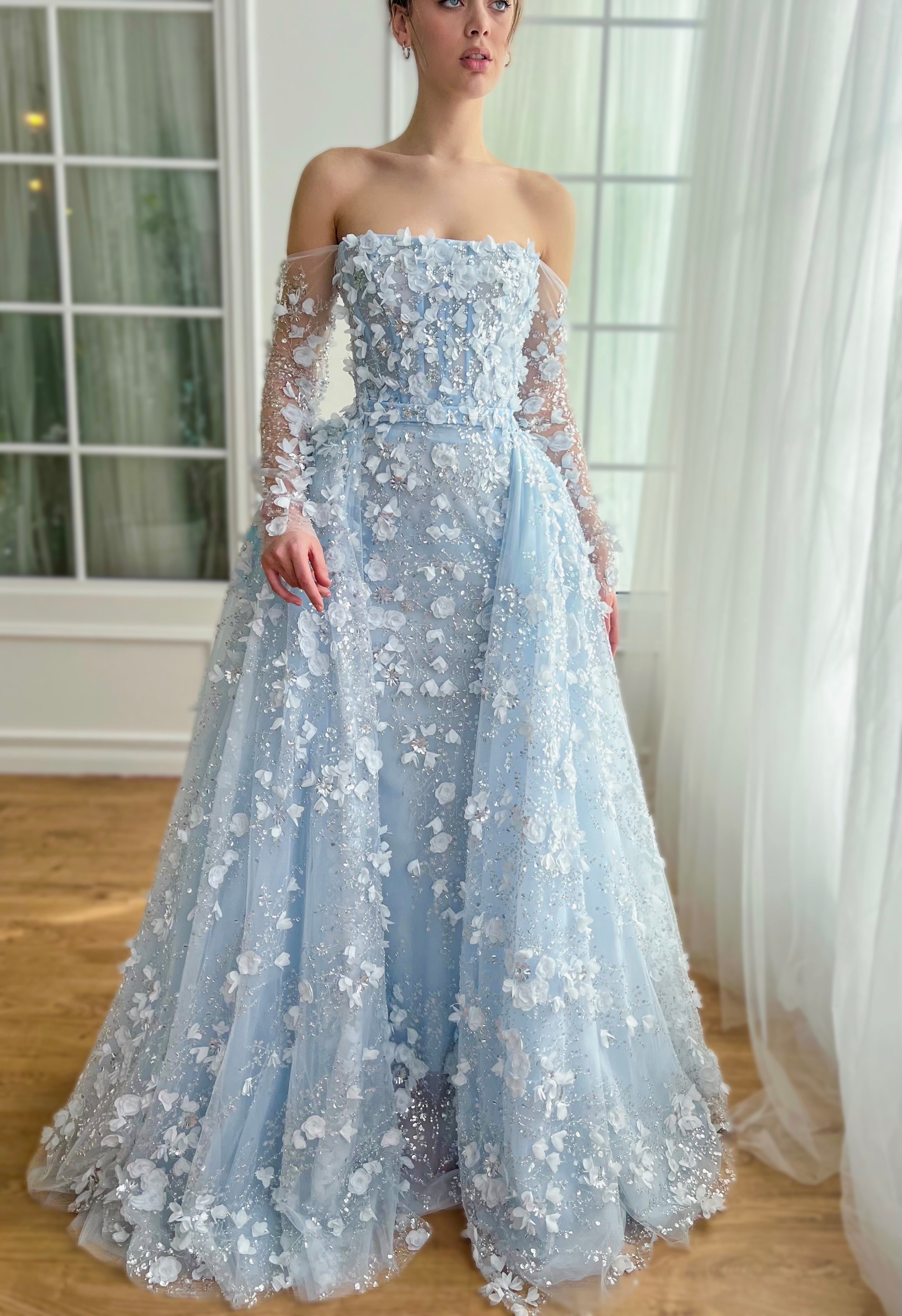 Light blue A-Line dress with long off the shoulder sleeves, overskirt and embroidery