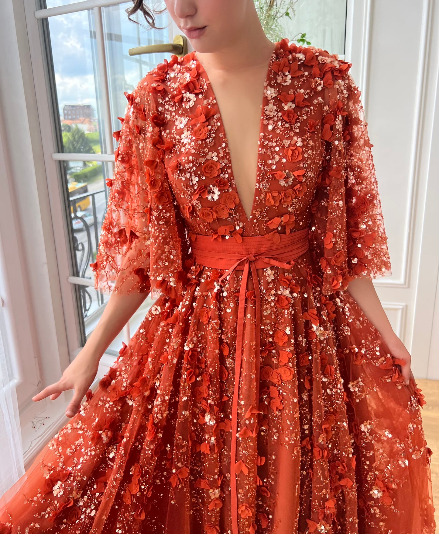 Orange a-line dress with flutter sleeves, v-neck and embroidery