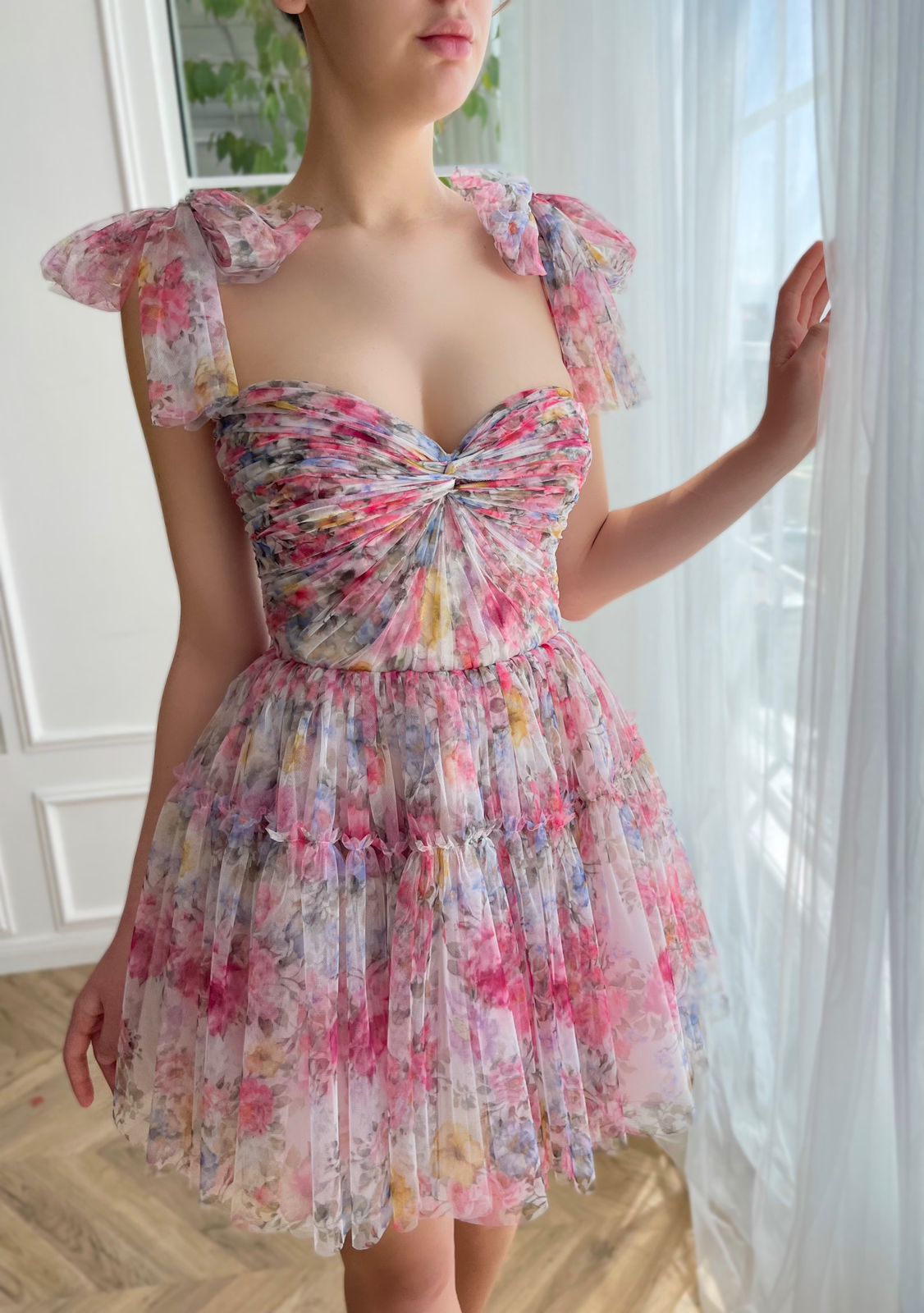 Pink mini dress with printed flowers and bow straps