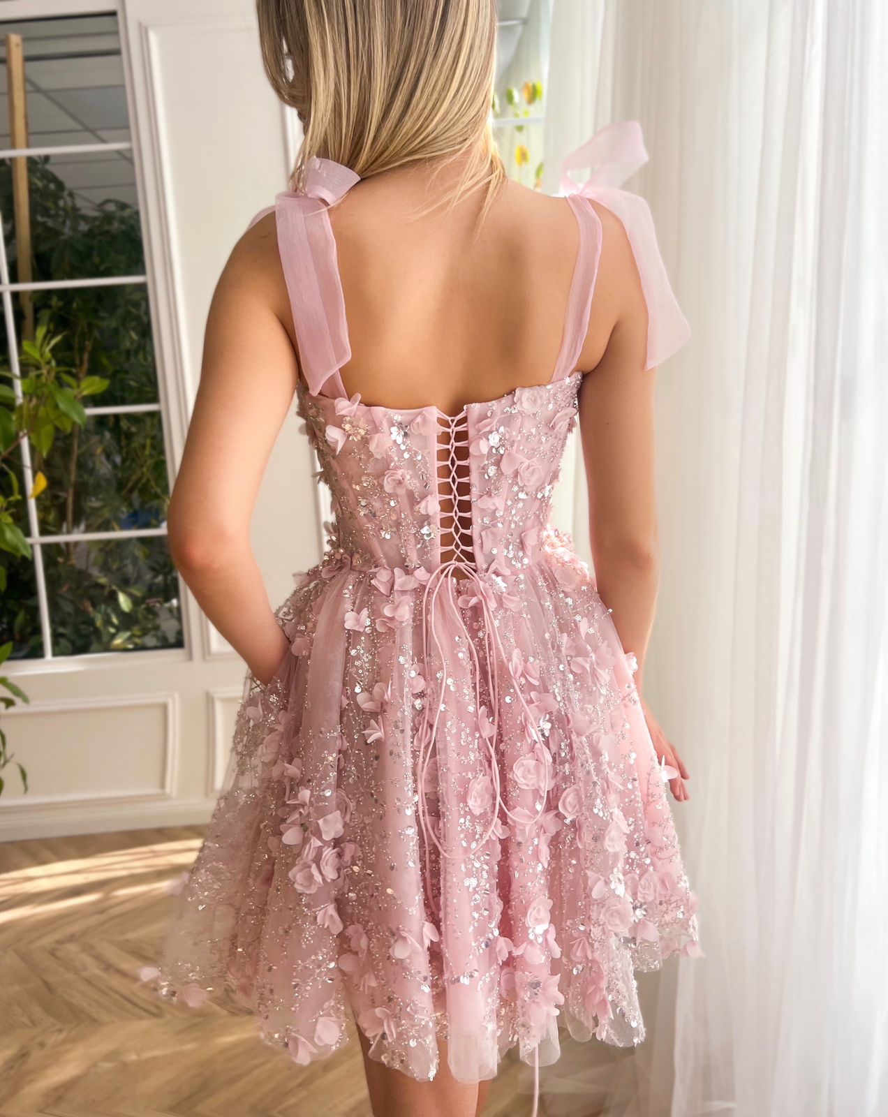 Pink mini dress with bow straps and embroidery