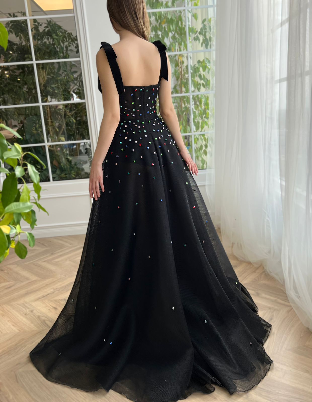 Black A-line dress with bow straps and embroidered jewels