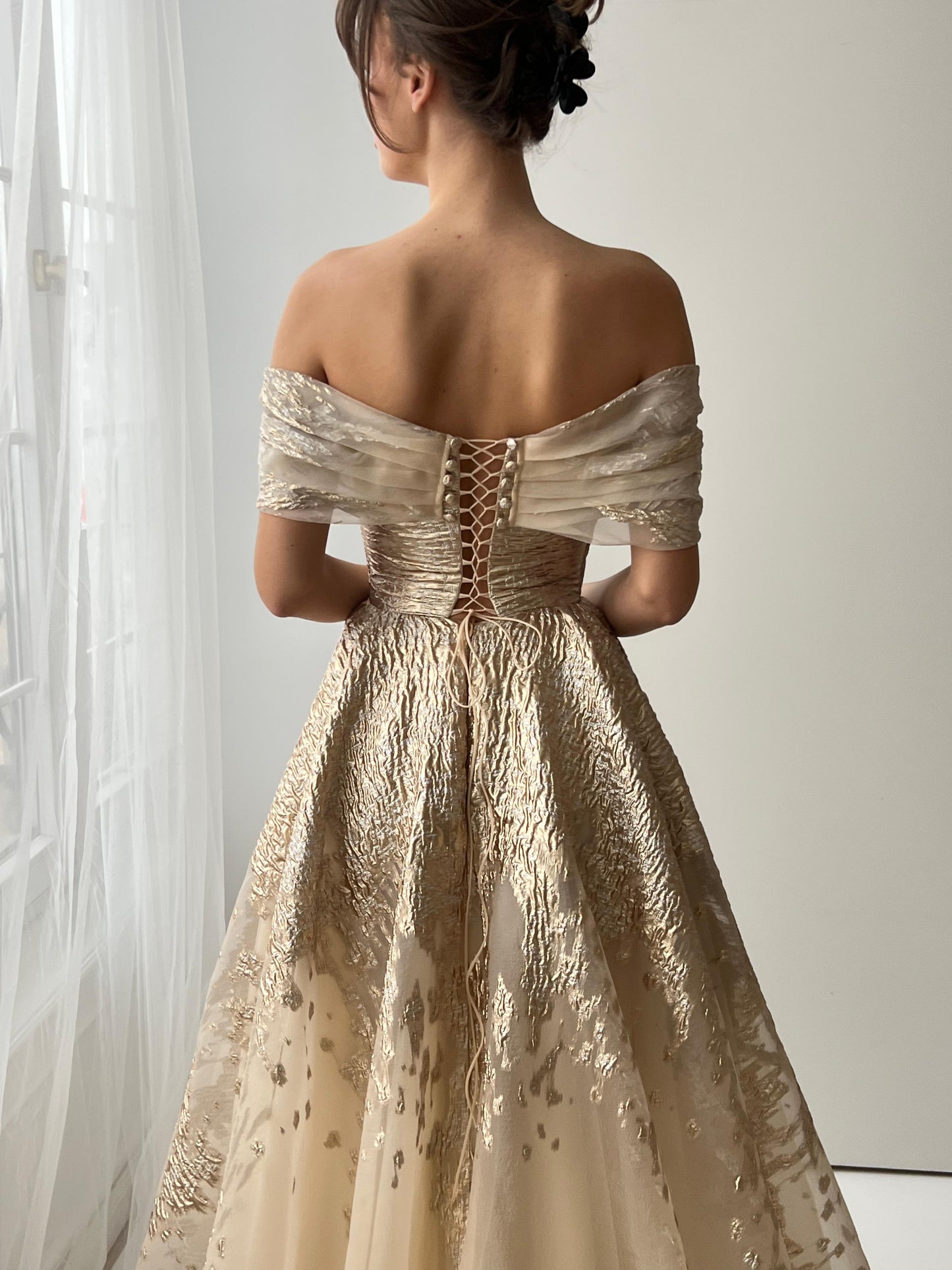 Beige A-Line dress with off the shoulder sleeves and brocade fabric