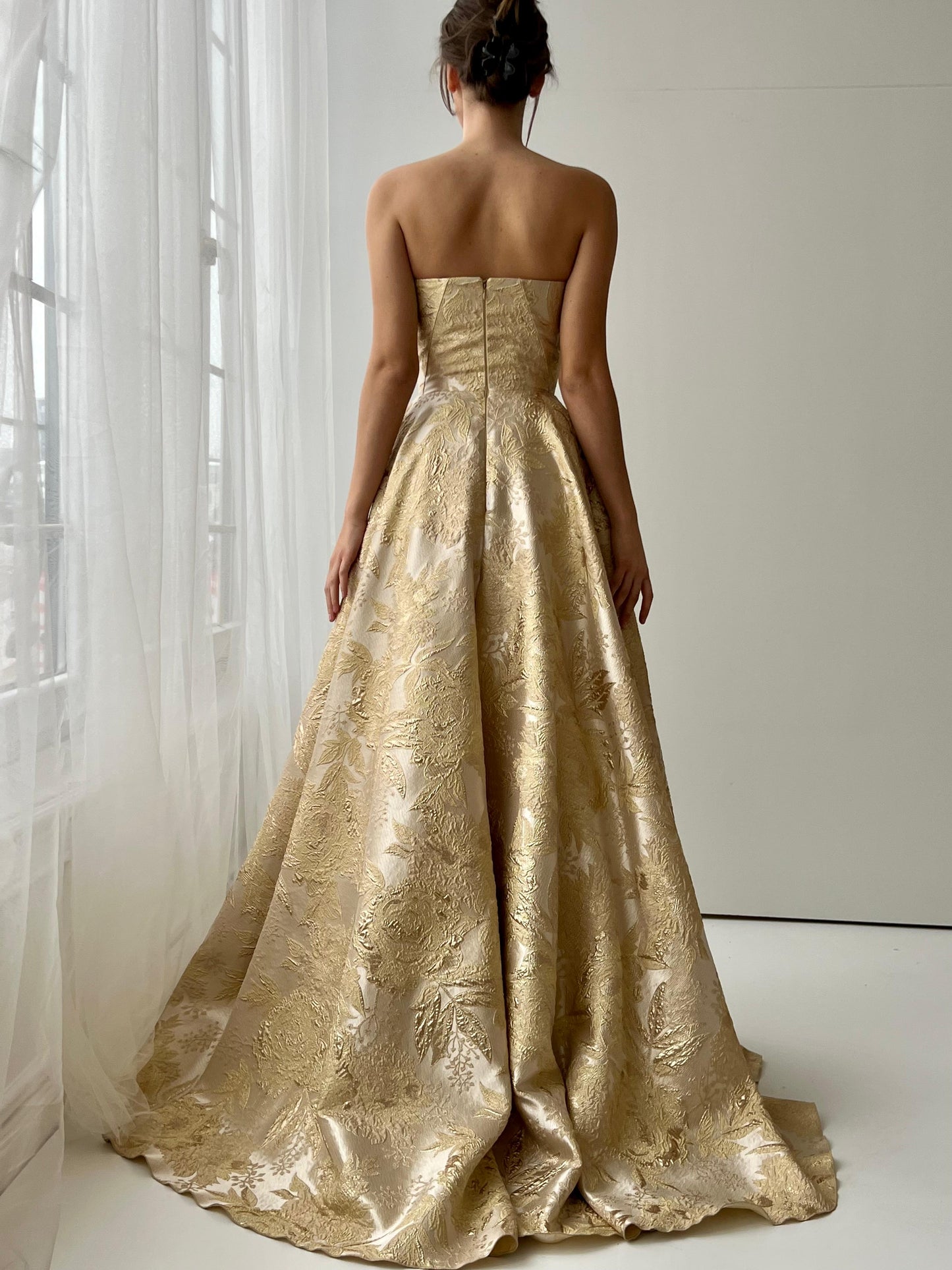 Beige A-Line dress with embroidered bow, brocade fabric and no sleeves