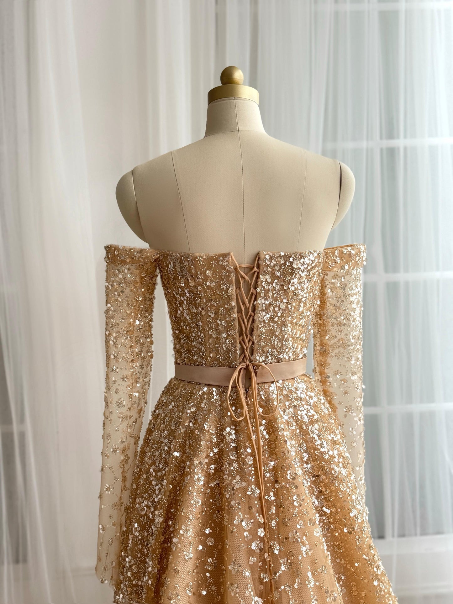 Beige A-Line dress with long off the shoulder sleeves and sequins