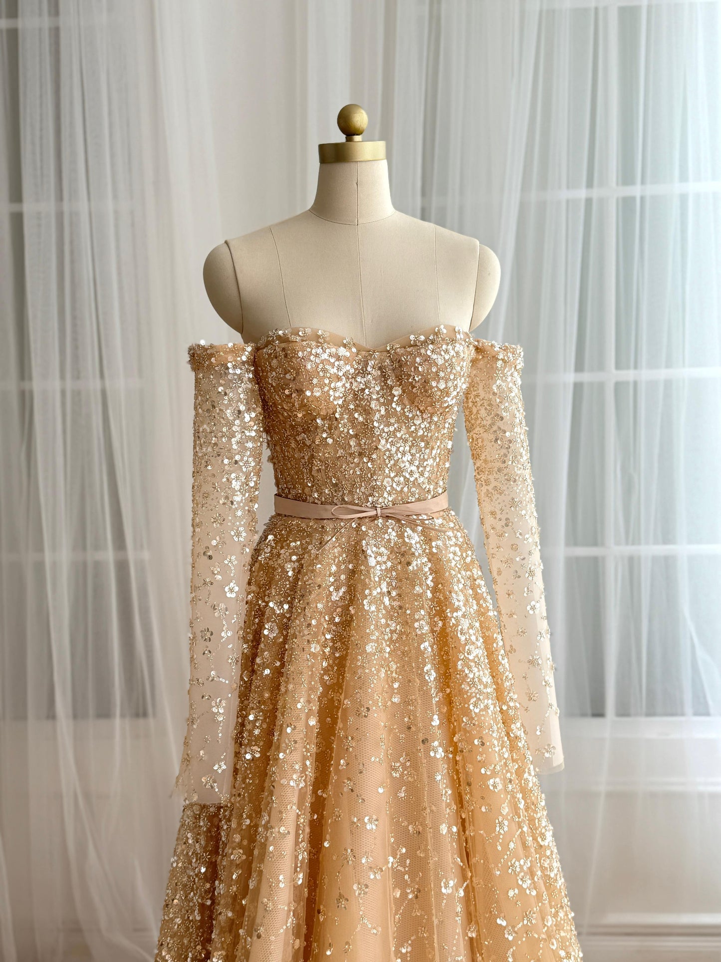 Beige A-Line dress with long off the shoulder sleeves and sequins