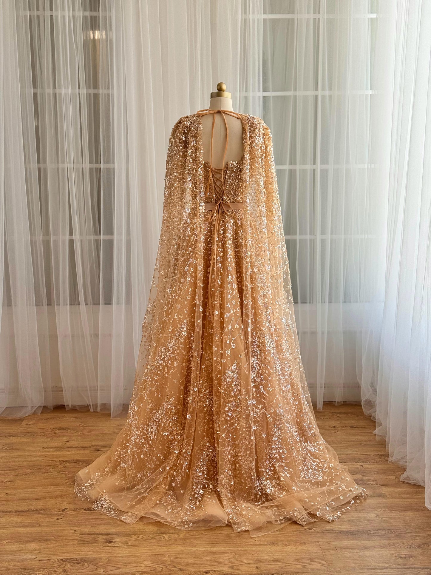 Beige A-Line gown with cape, no sleeves and sequins