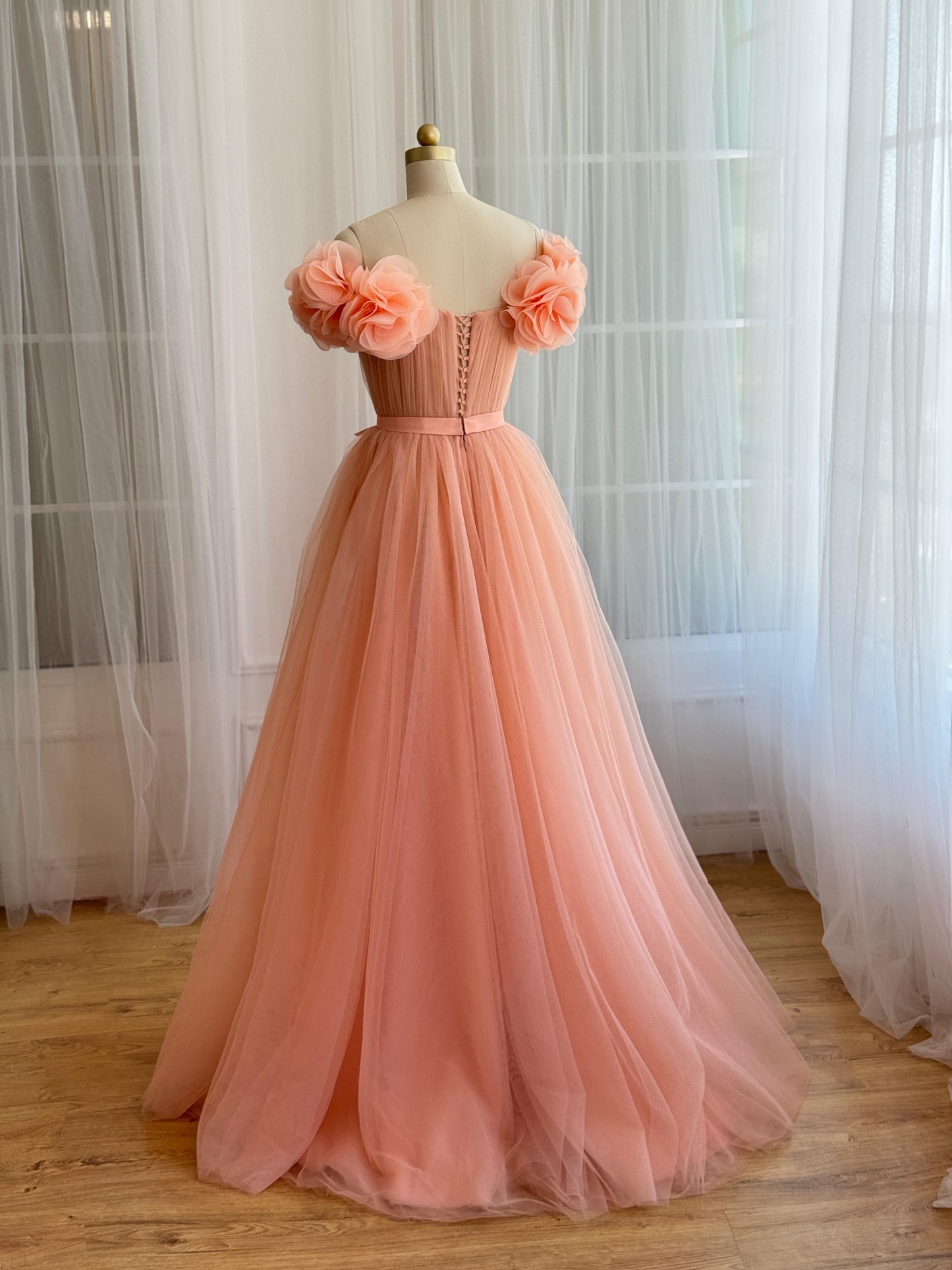 Peach A-Line gown with off the shoulder sleeves and embroidered flowers