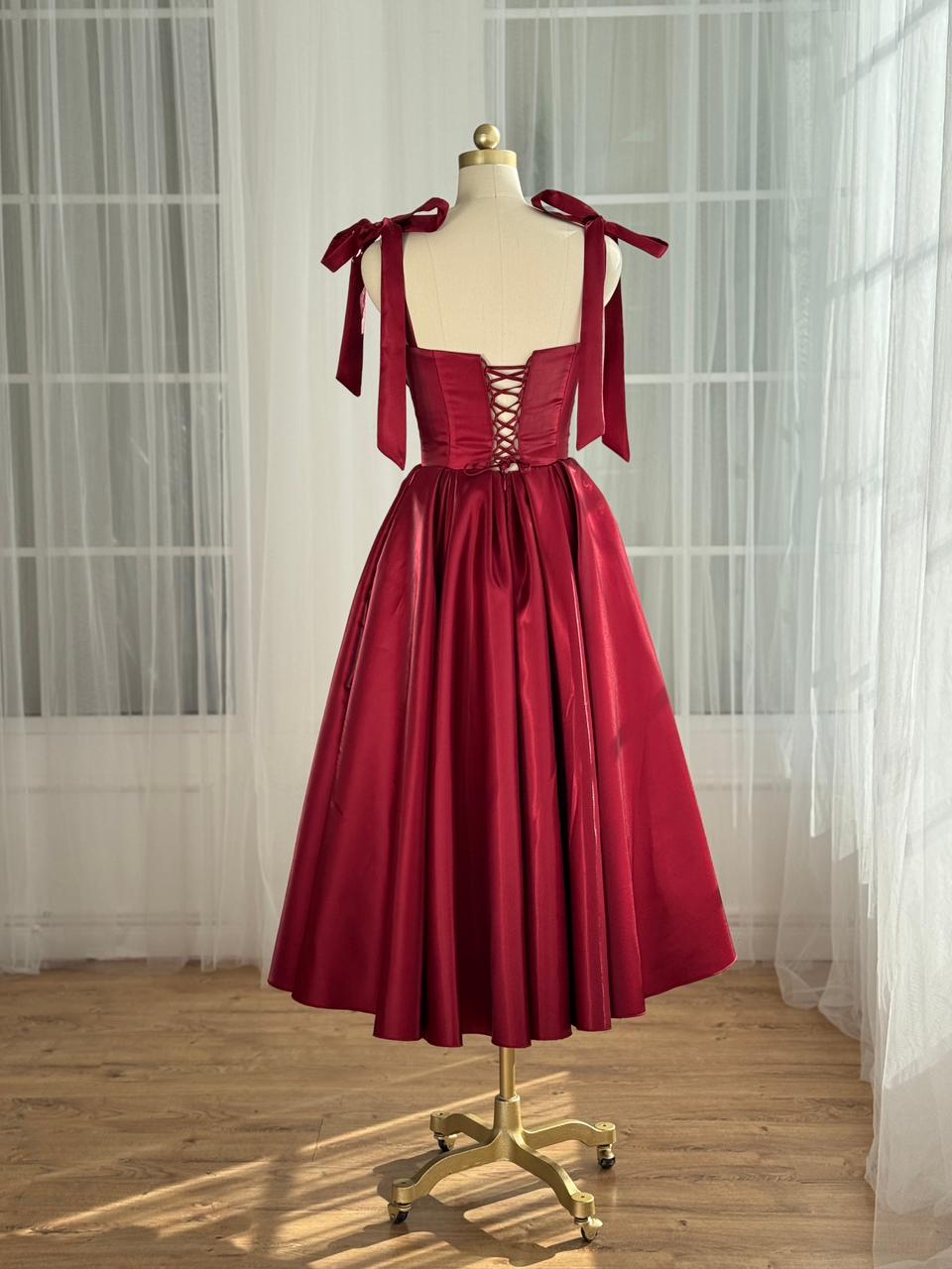 Red midi dress with bow straps and floral trim