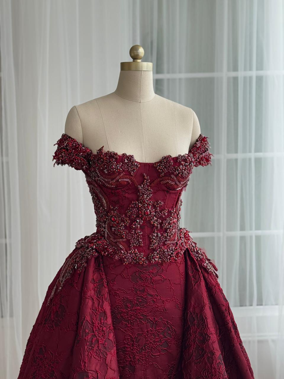 Red A-Line gown with overskirt, off the shoulder sleeves and embroidery
