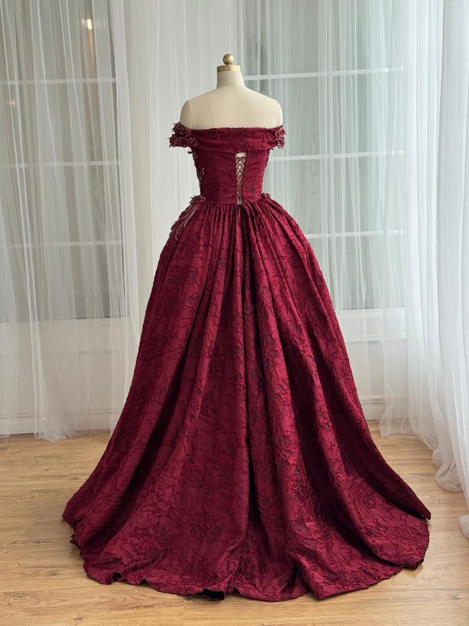 Red A-Line gown with overskirt, off the shoulder sleeves and embroidery