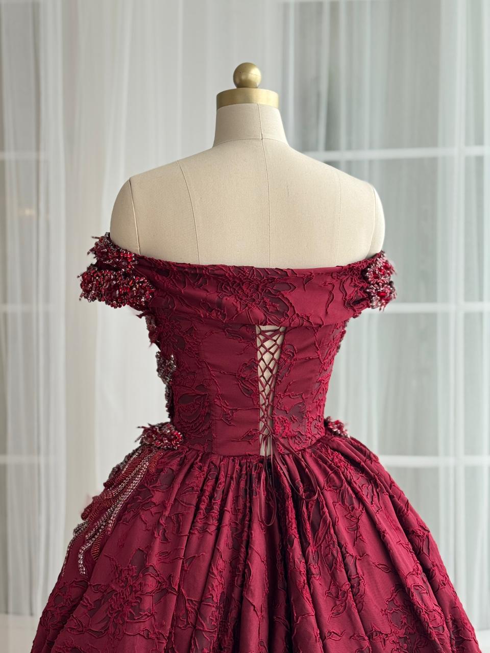 Red A-Line gown with overskirt, off the shoulder sleeves and embroidery