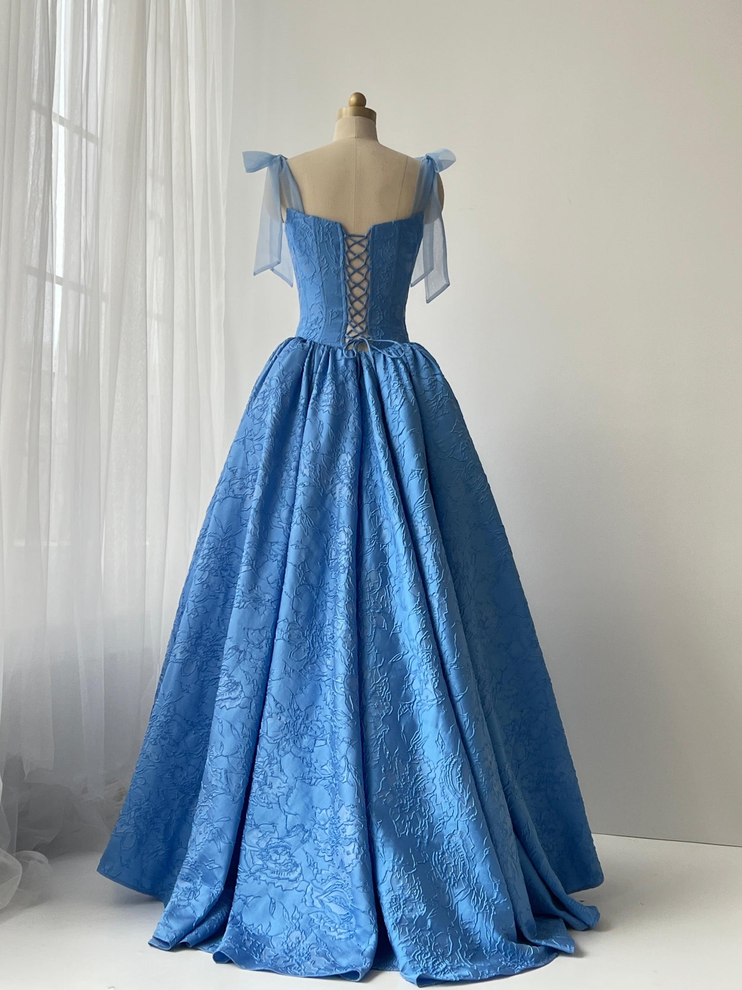 Blue A-Line gown with bow straps and brocade fabric