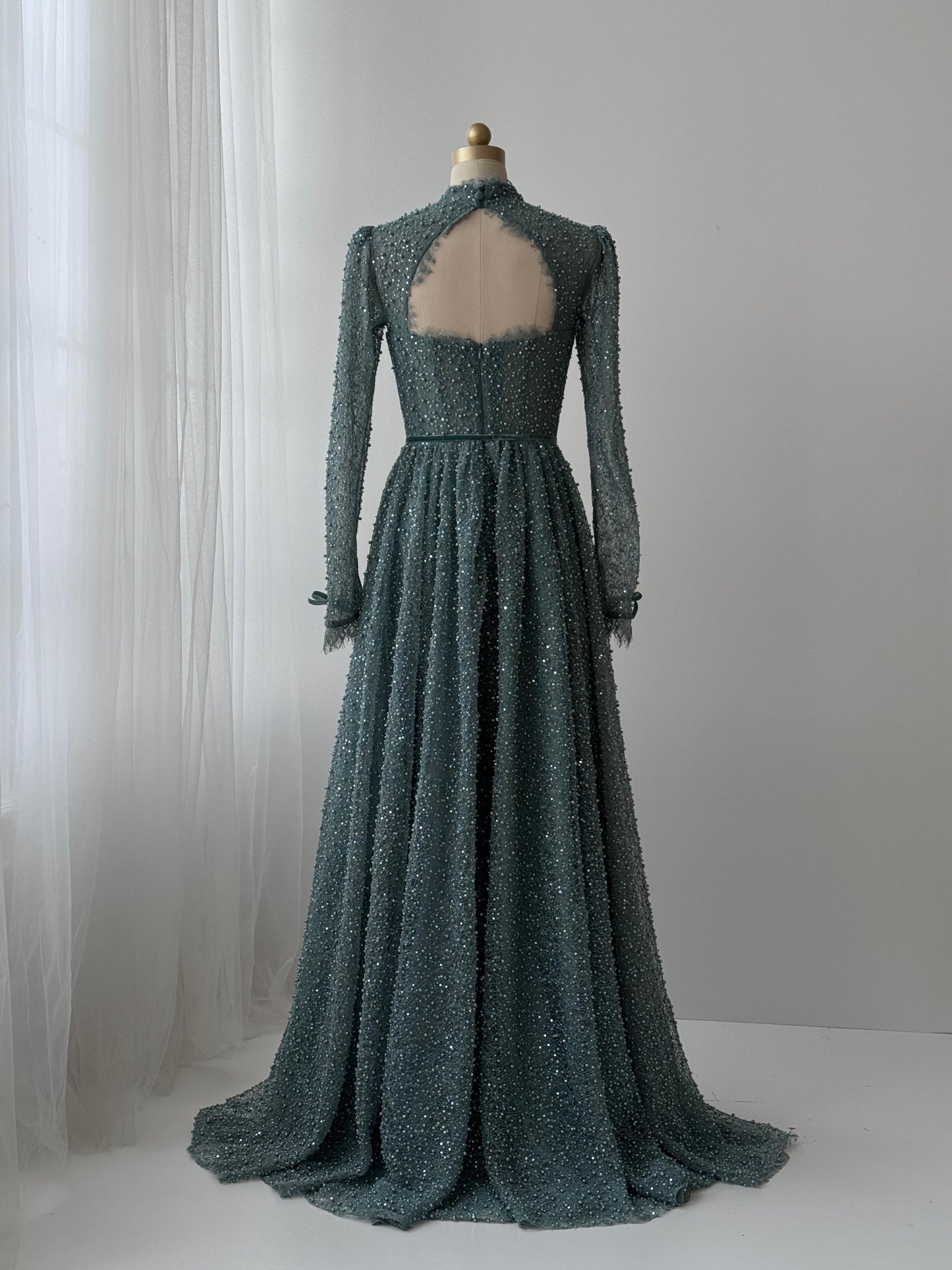 Turquoise A-Line gown with long sleeve, bolero, beading and embroidered bows