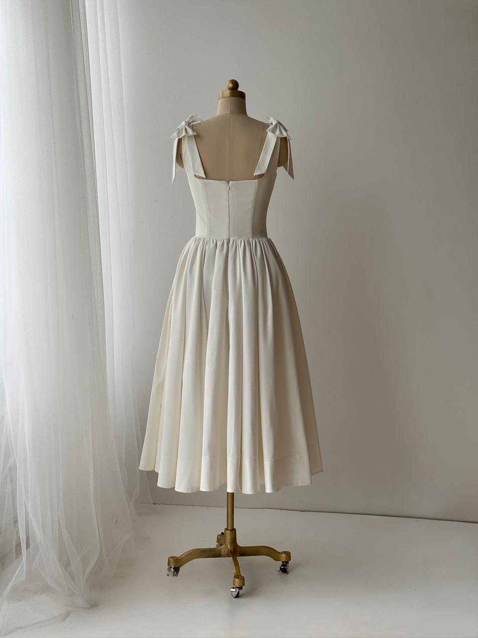 White bridal midi dress with bow straps and taffeta fabric