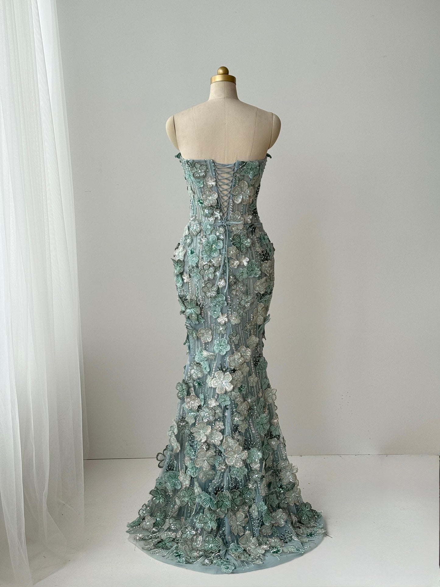 Turquoise mermaid gown with embroidered flowers and no sleeves