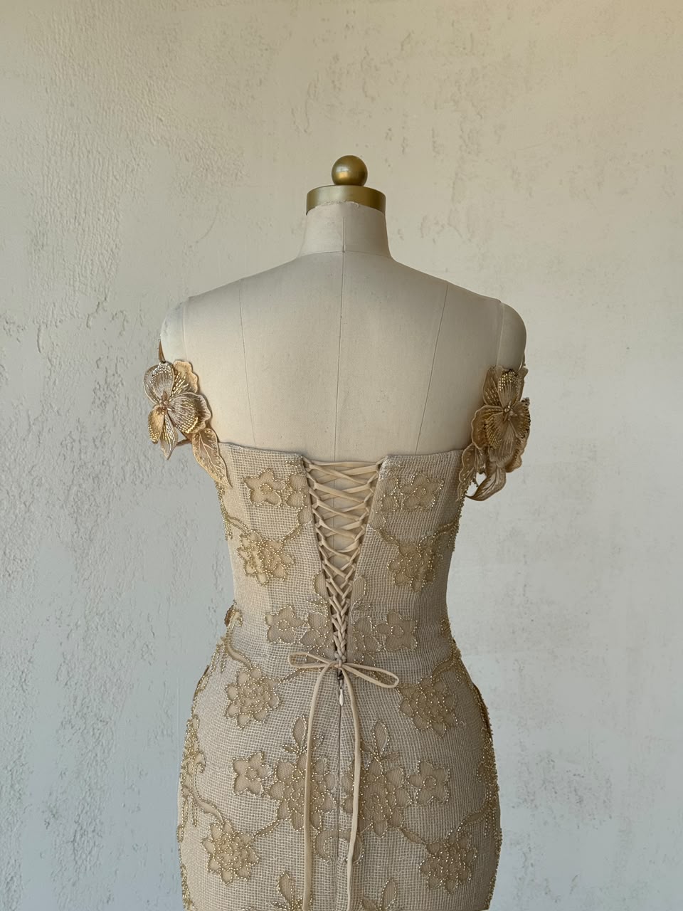 Beige mermaid gown with off the shoulder sleeves and embroidery