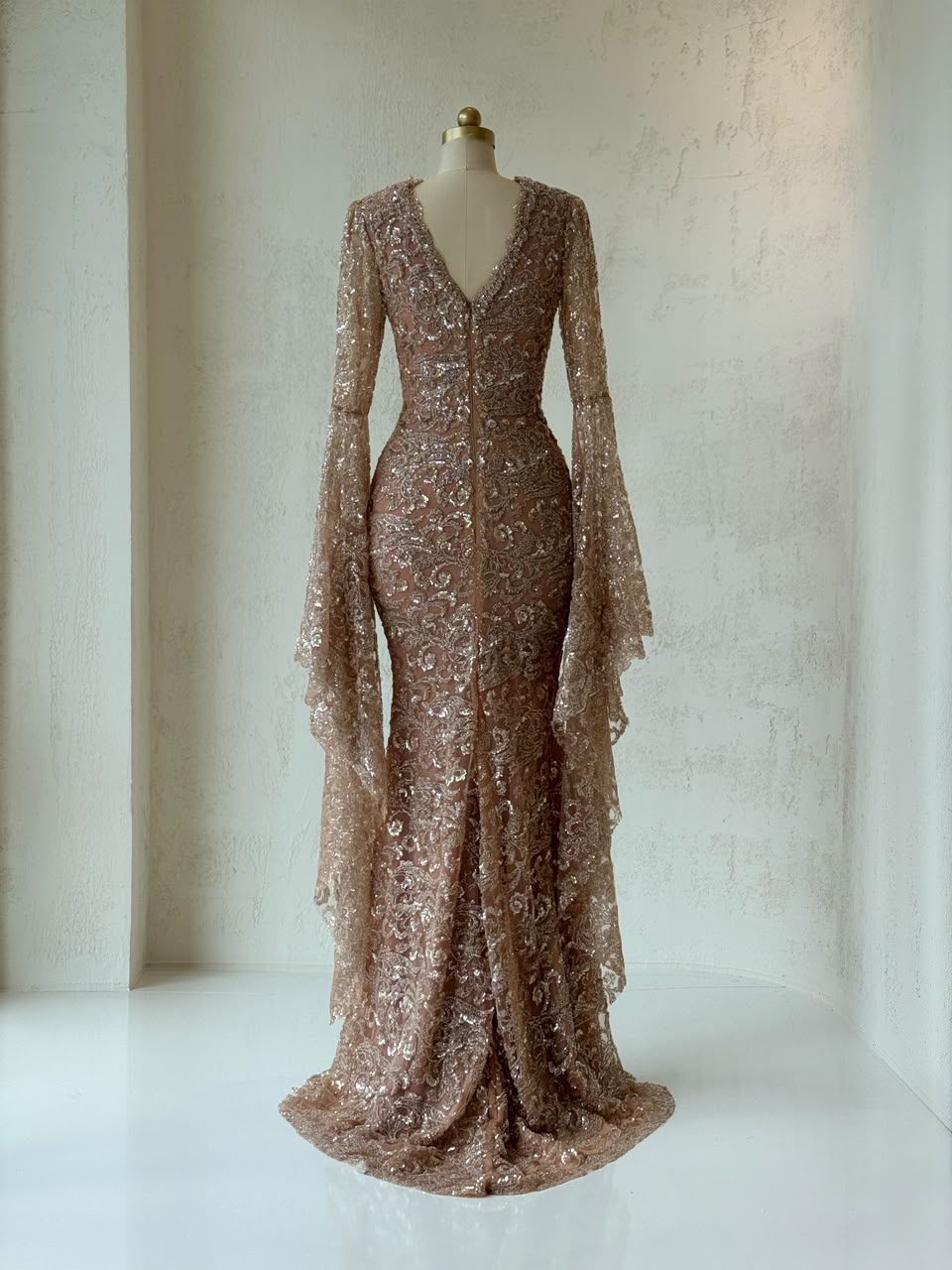 Rose gold mermaid gown with v-neck, embroidered bow, long flutter sleeves and sequins