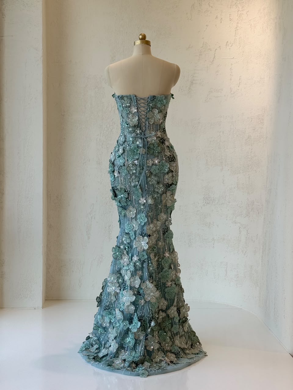 Turquoise mermaid gown with embroidered flowers and no sleeves