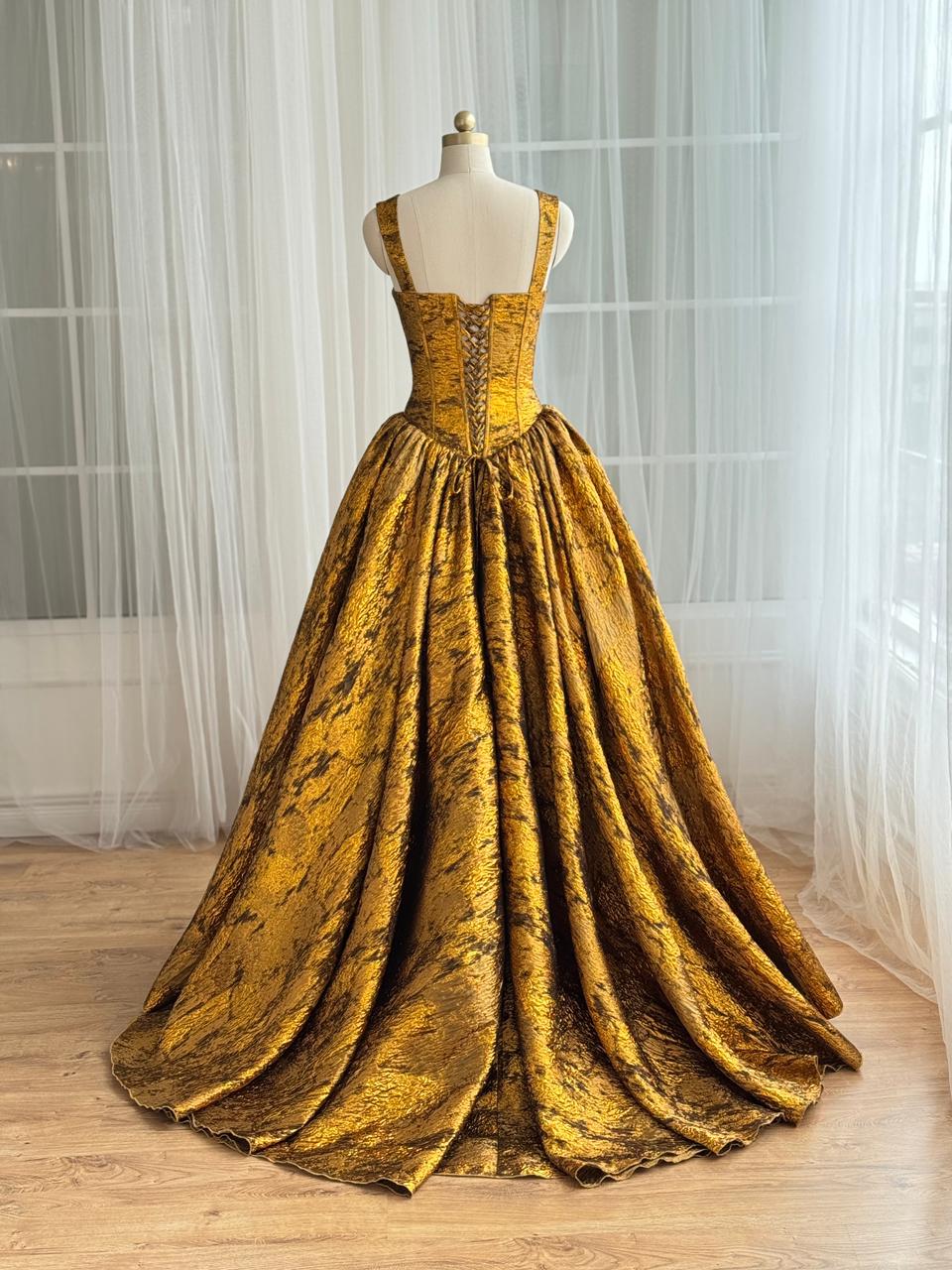 Gold A-Line gown with straps and brocade fabric