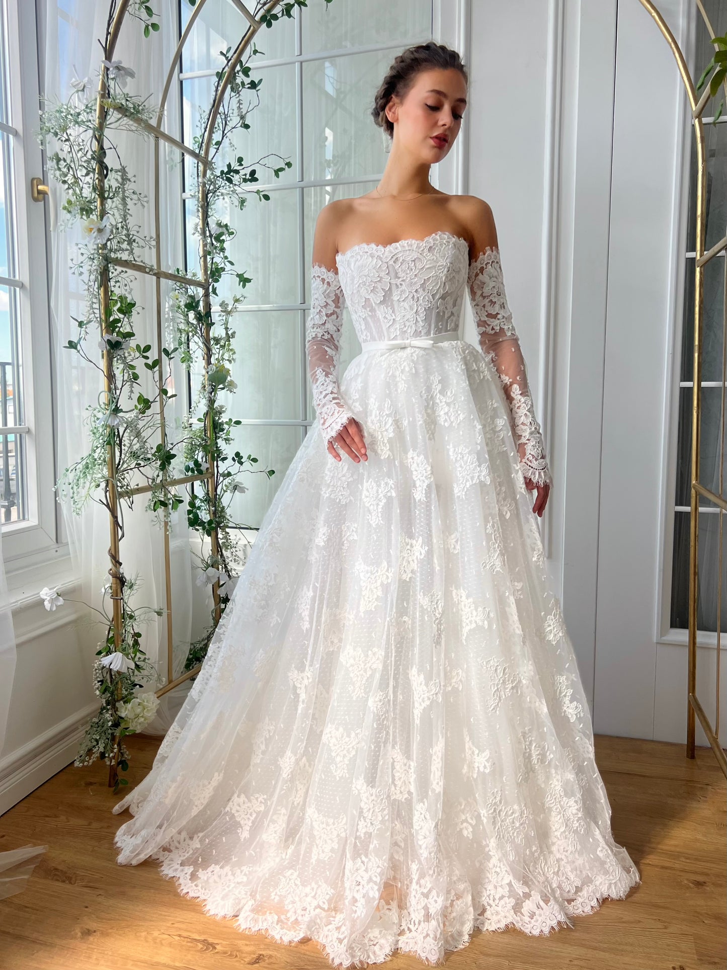 White bridal A-Line gown with long off the shoulders sleeves and embroidery