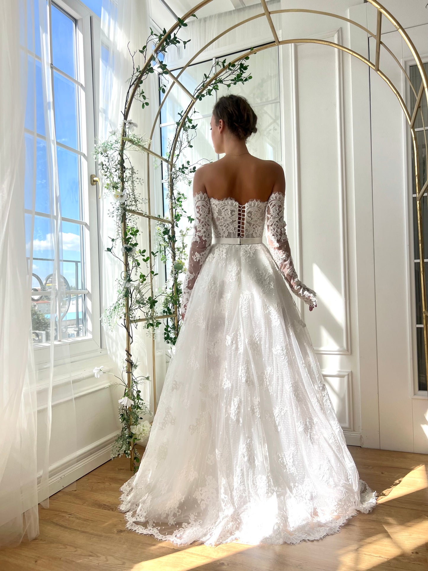 White bridal A-Line gown with long off the shoulders sleeves and embroidery