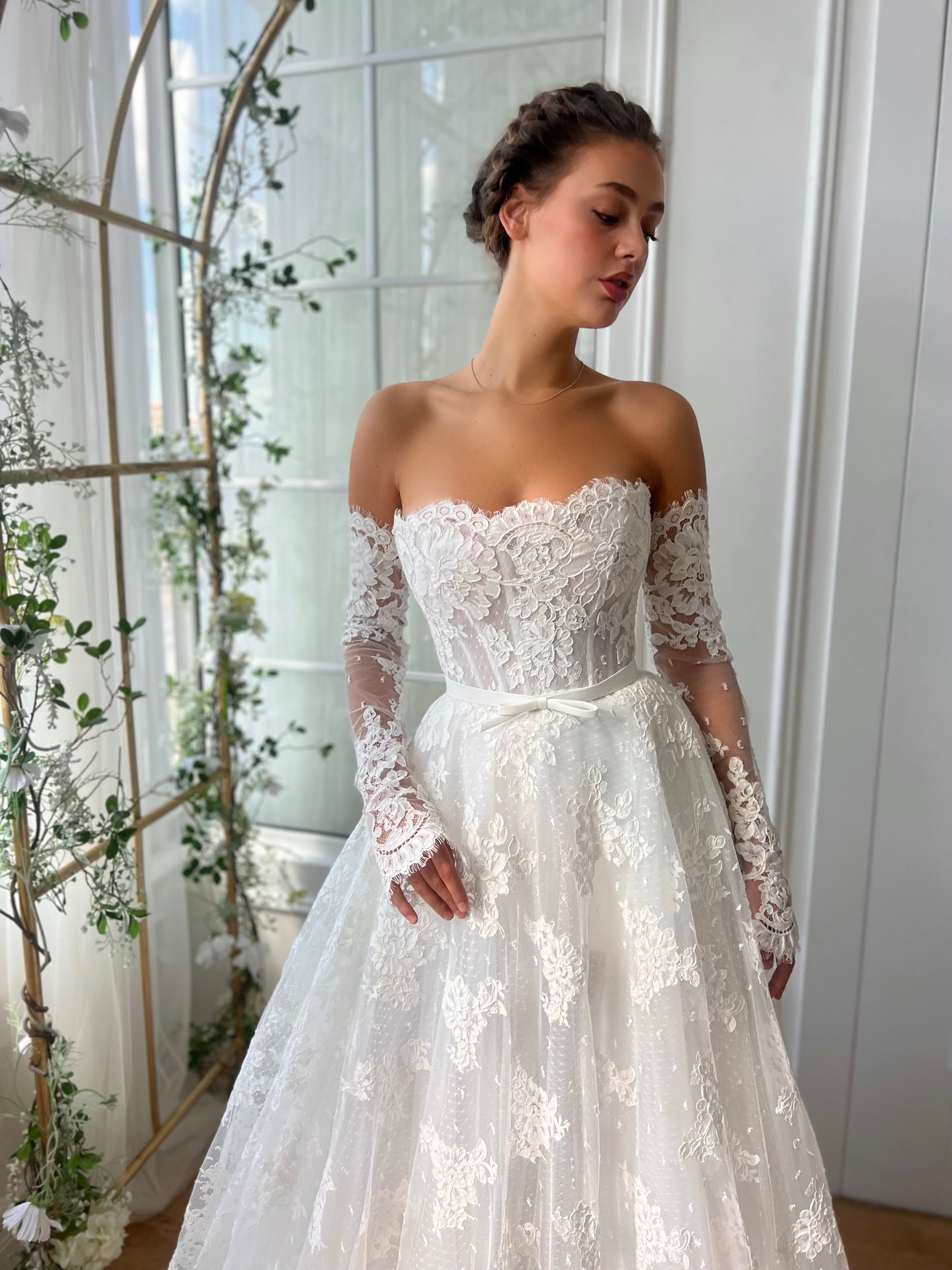 White bridal A-Line gown with long off the shoulders sleeves and embroidery