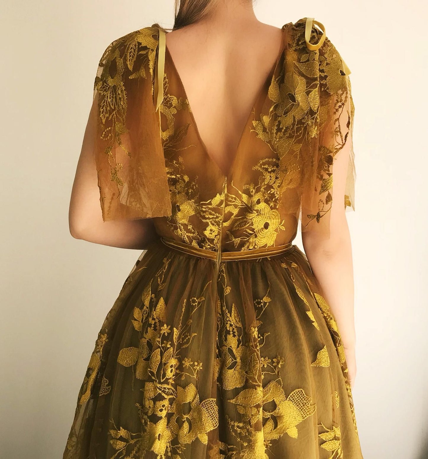 Gold A-Line dress with v-neck, no sleeves, lace and embroidery