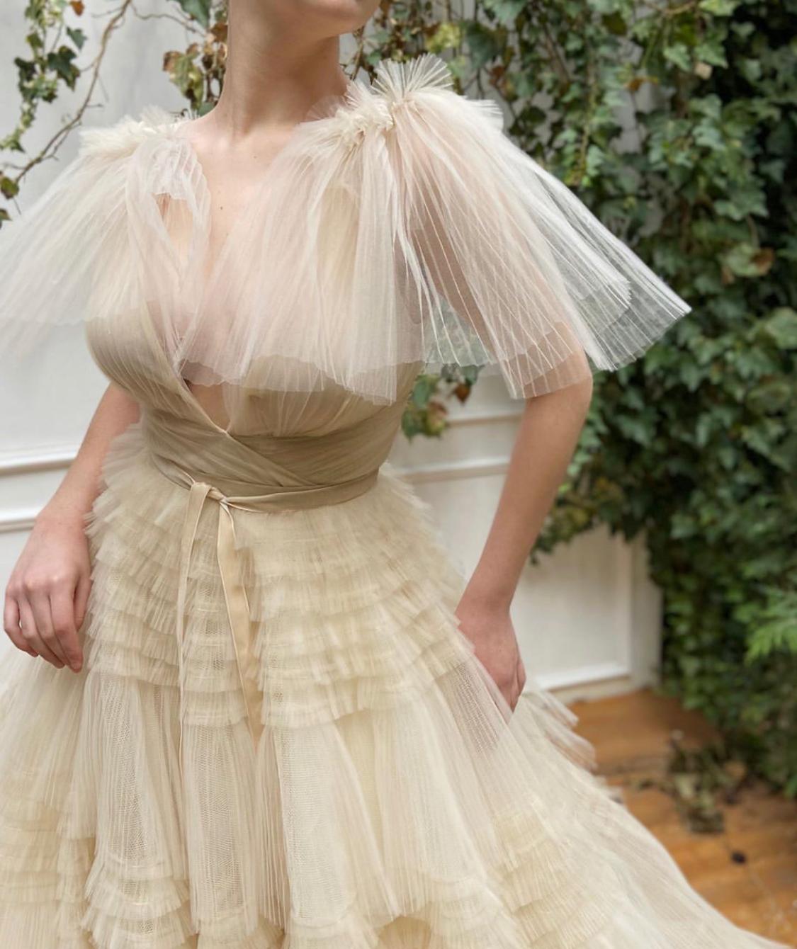 Beige A-Line dress with no sleeves, v-neck and ruffles