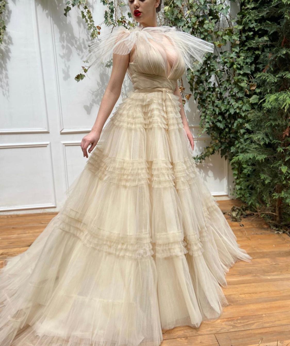 Beige A-Line dress with no sleeves, v-neck and ruffles