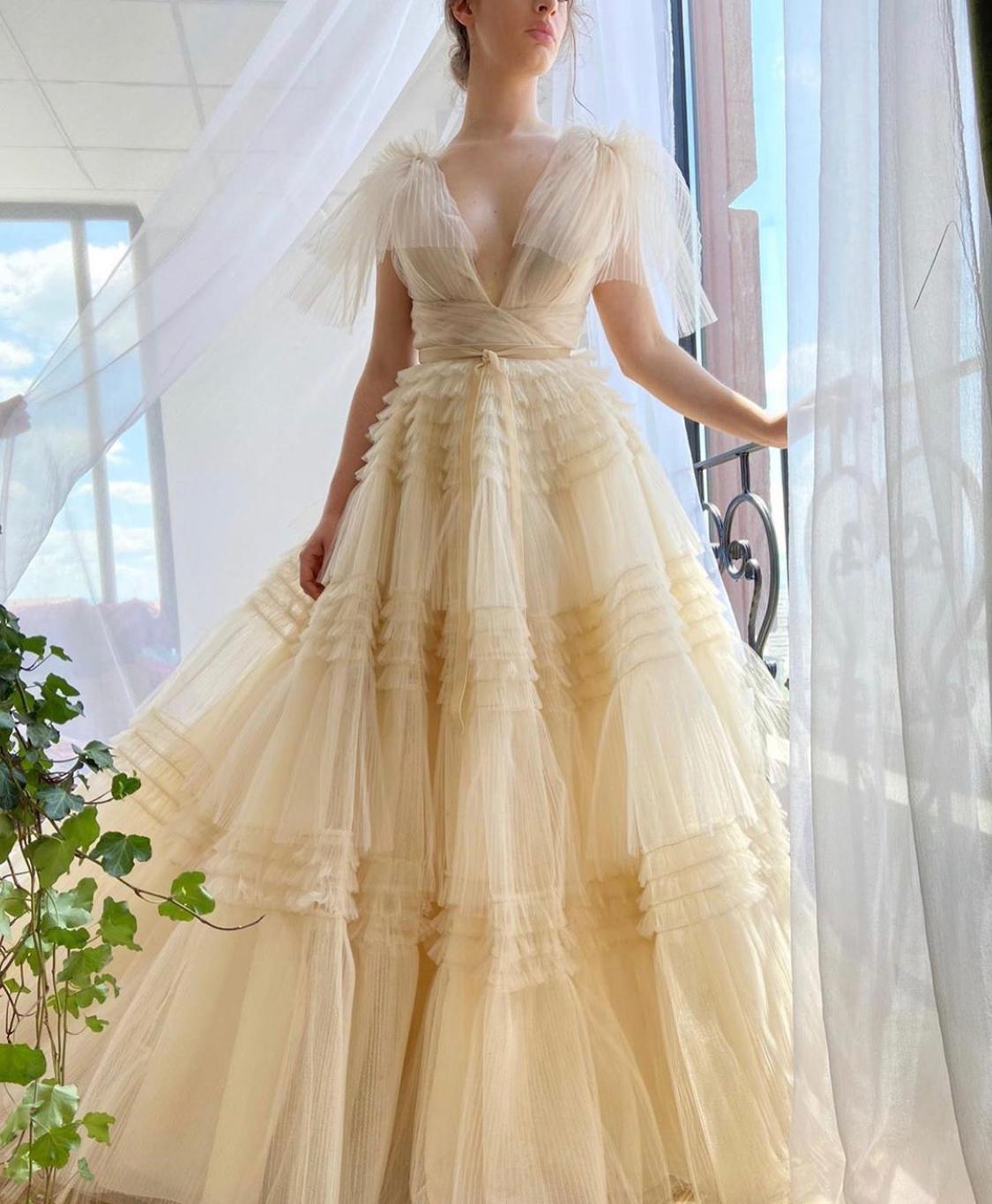 Beige A-Line dress with no sleeves, v-neck and ruffles