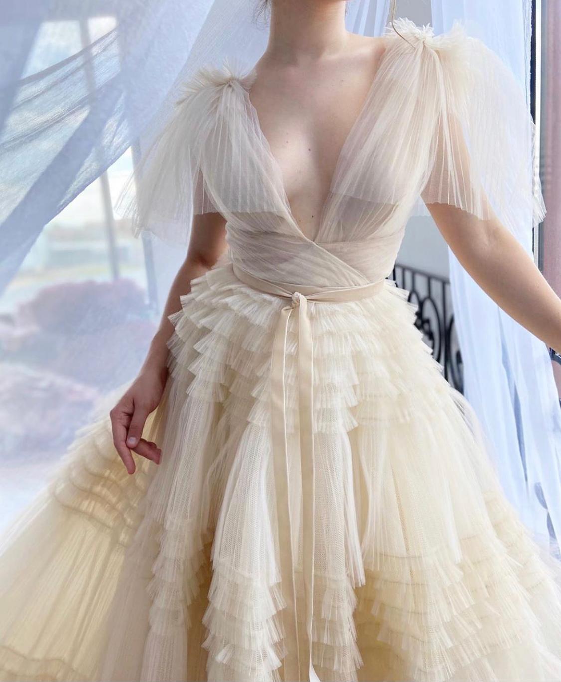 Beige A-Line dress with no sleeves, v-neck and ruffles