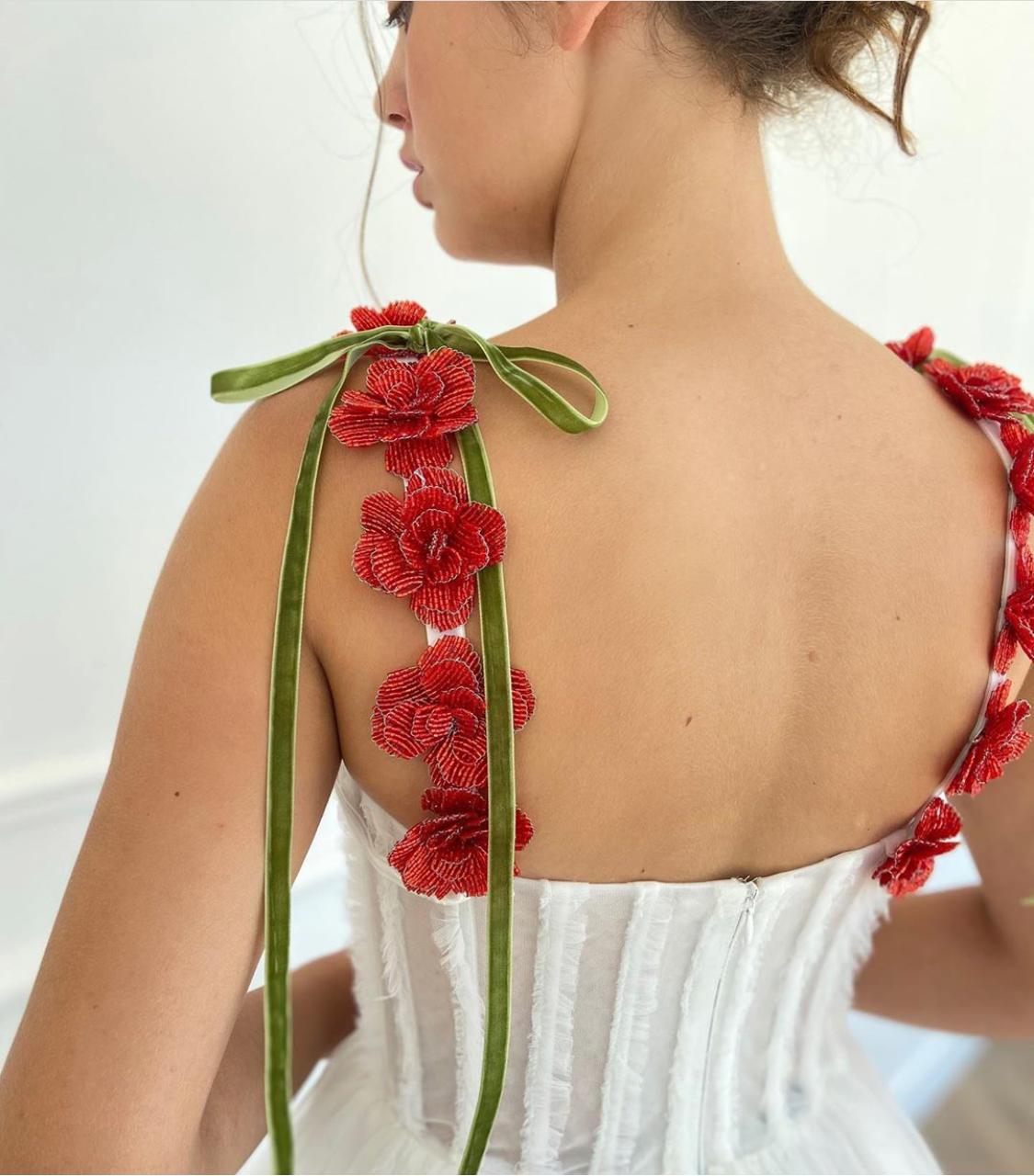 A line white bridal dress with embroidered flowers and spaghetti straps