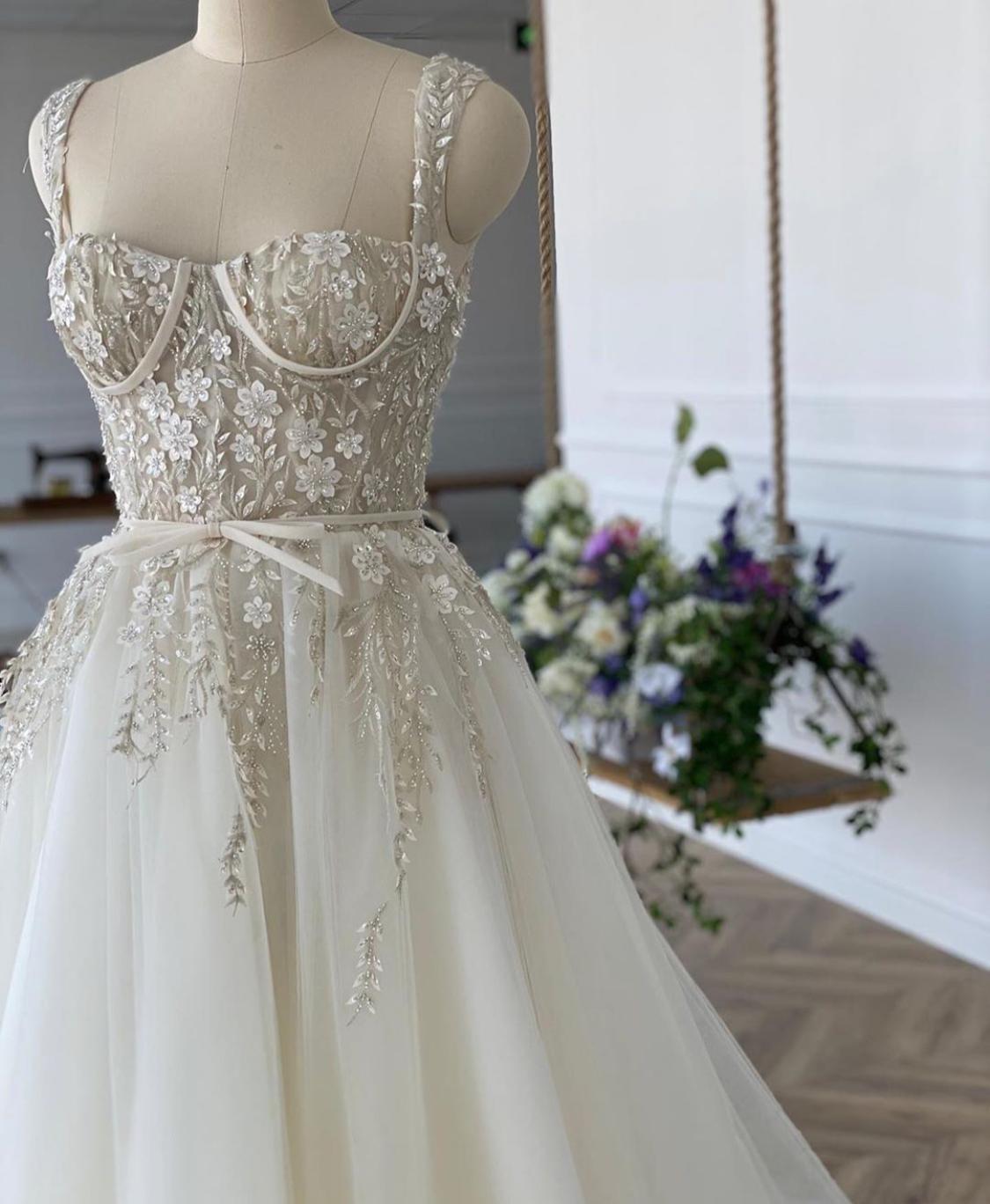 A line white bridal dress with embroidered flowers, straps and train