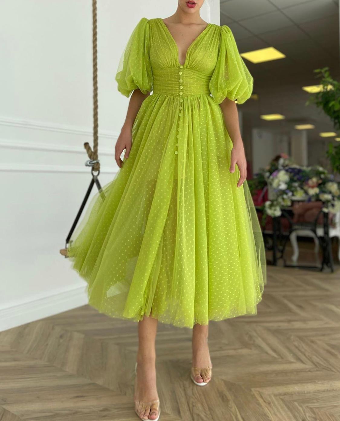 Green dotted midi dress with short sleeves and v-neck
