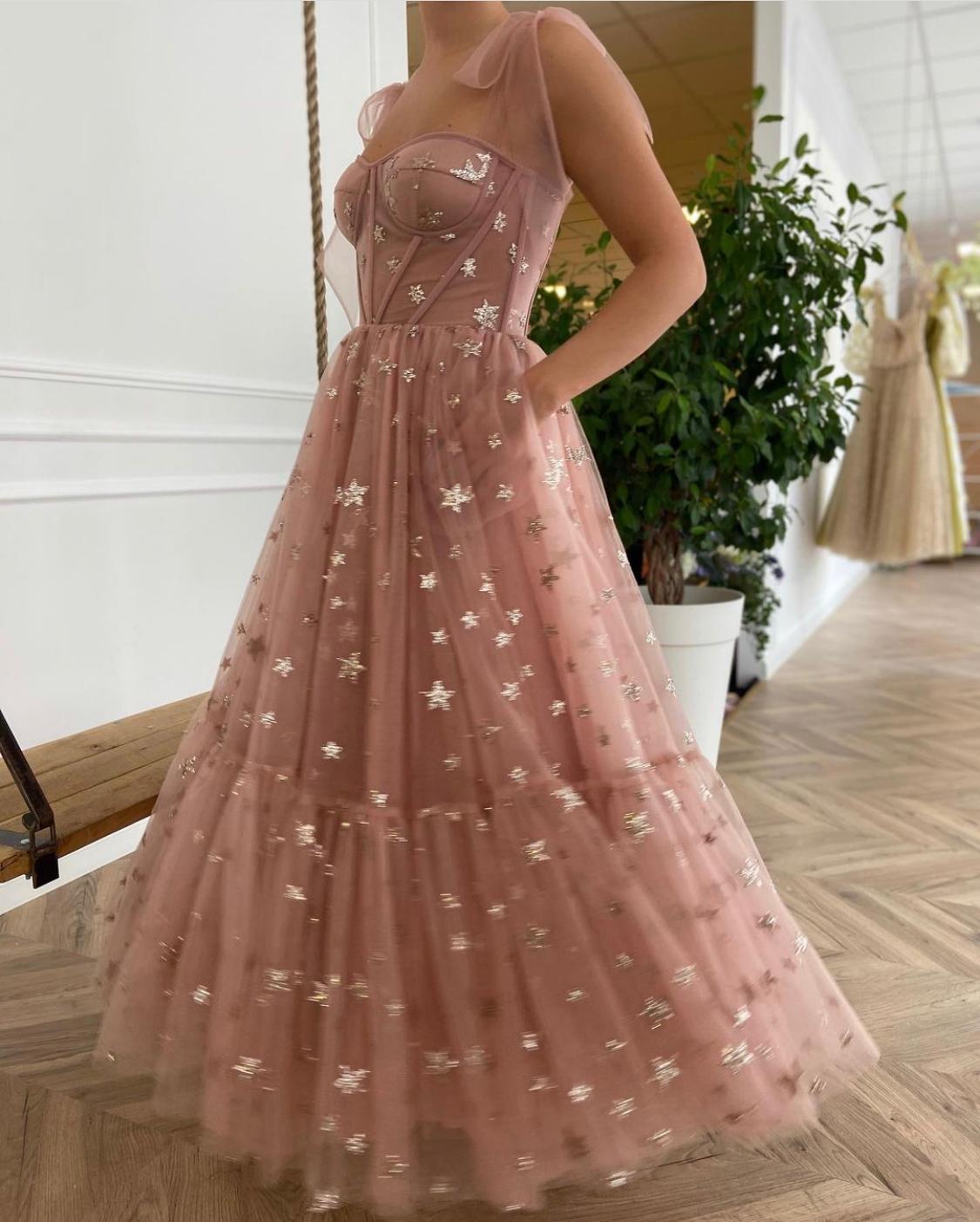 Pink midi dress with bow straps and starry fabric