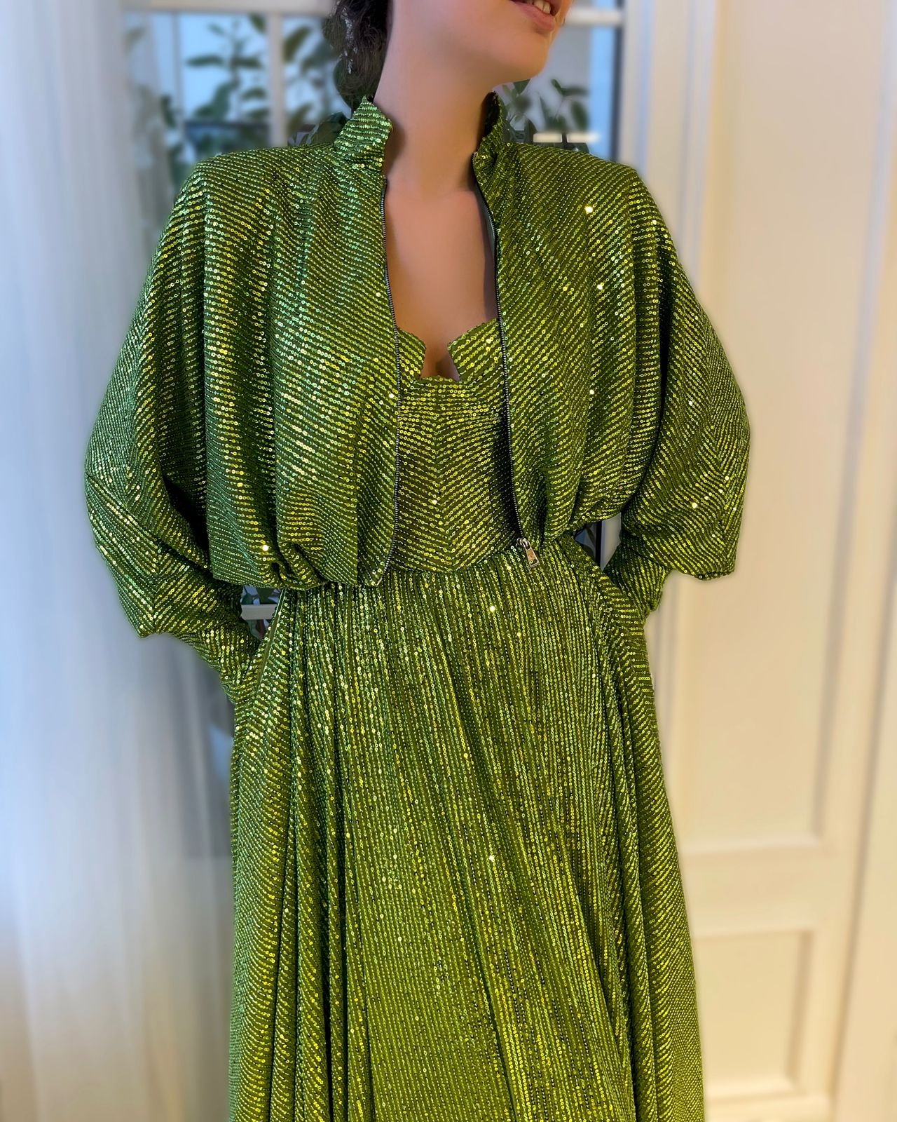 Green two piece dress with long sleeves and sequins