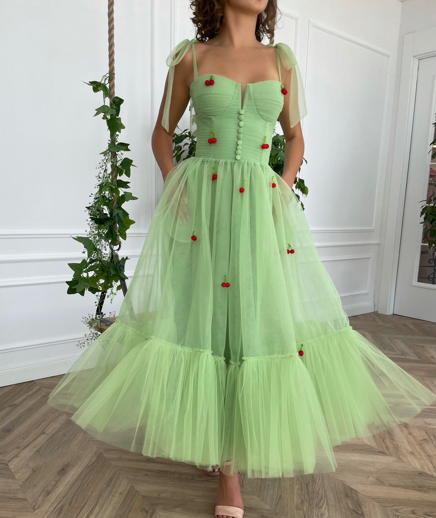 Green midi dress with bow straps and embroidered cherries