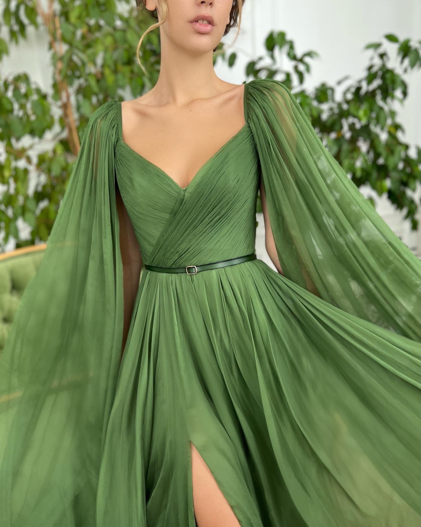 Green A-Line dress with v-neck, belt and cape sleeves 