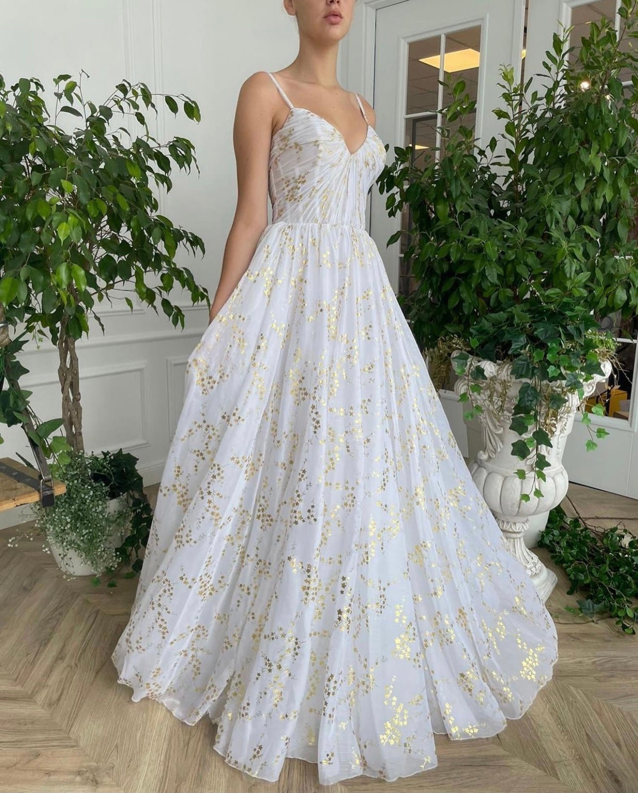 A line white bridal dress with cape, printed flowers and train