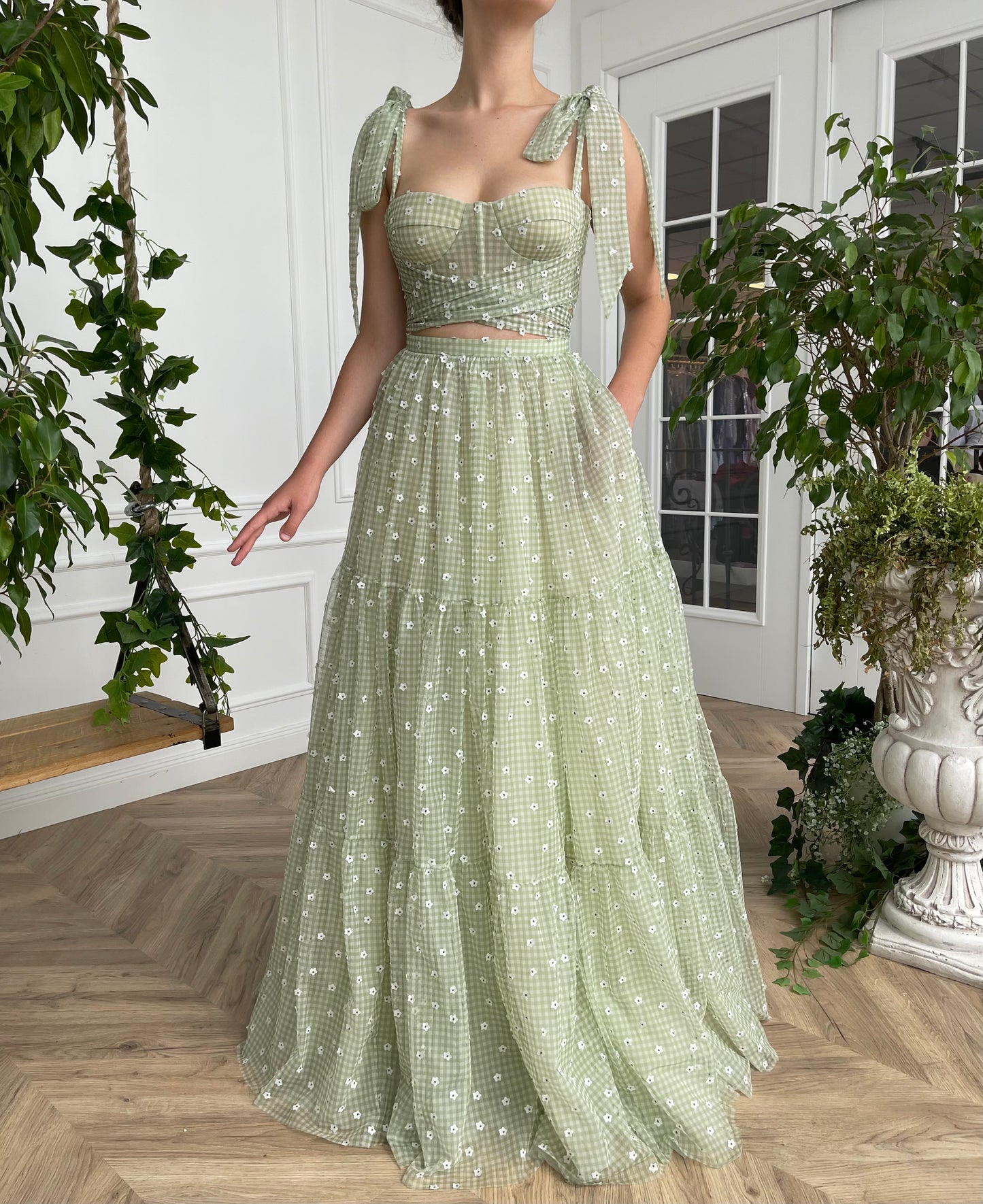 Green two piece dress with bow straps and daisies