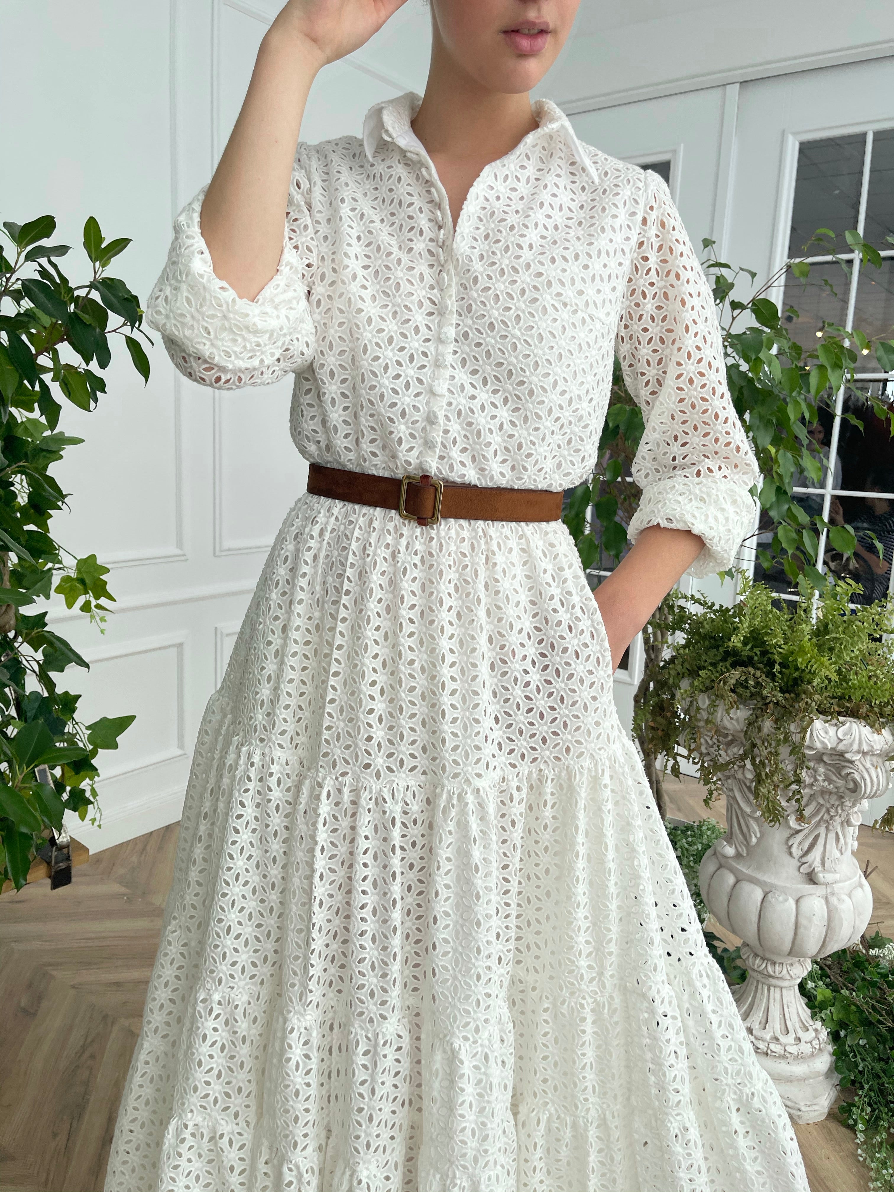 A line white bridal dress with brown belt and long sleeves