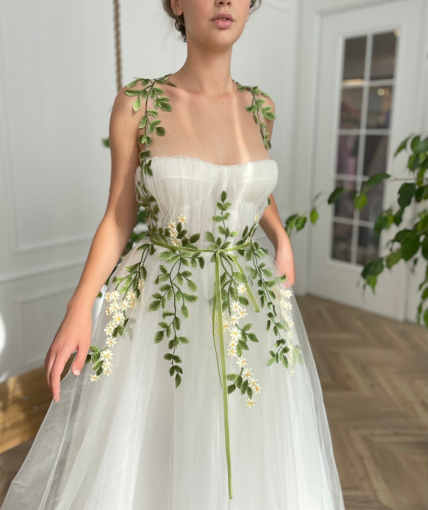 A line white bridal dress with straps and embroidered flowers