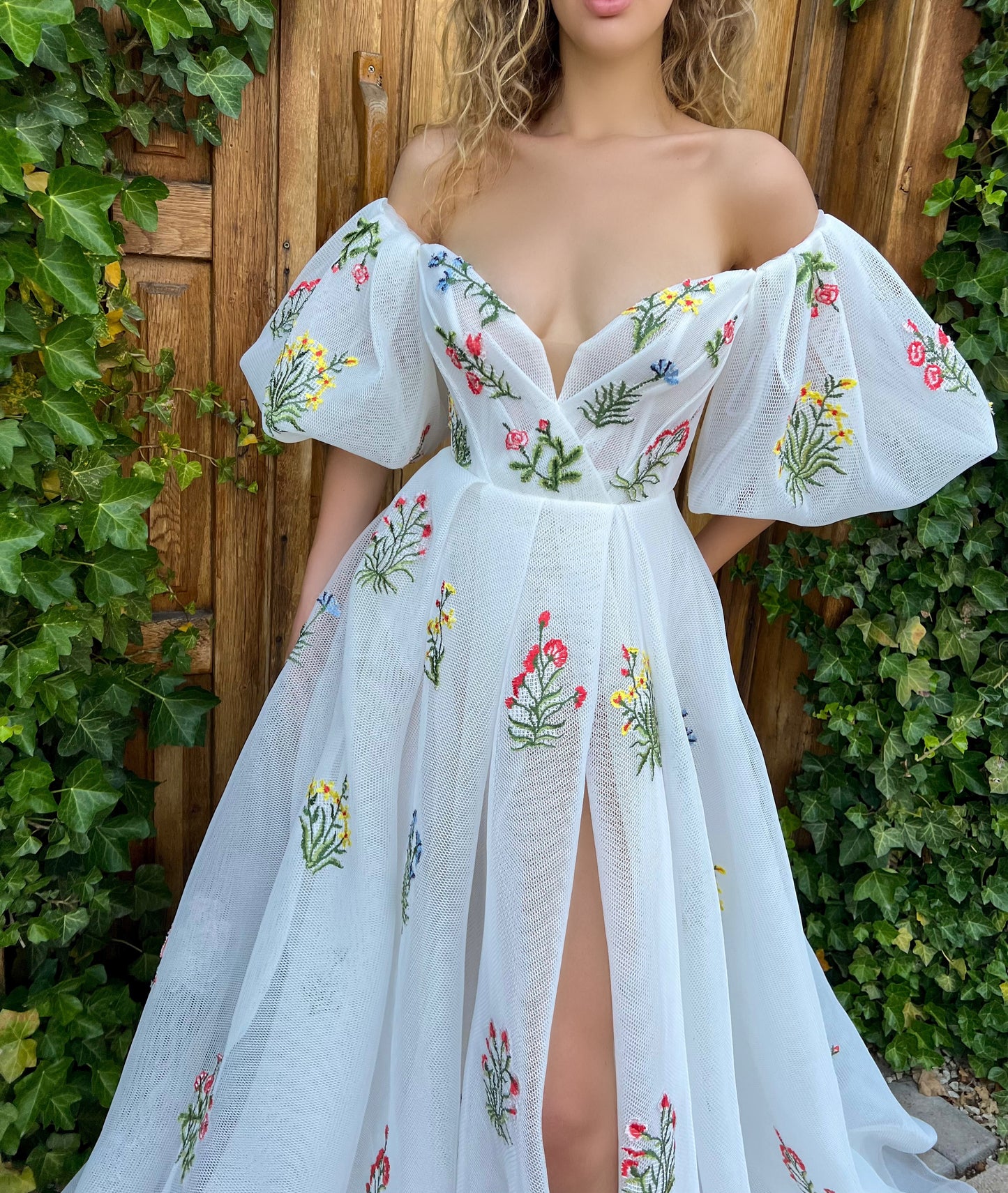 A line white bridal dress with embroidered flowers and off shoulder sleeves