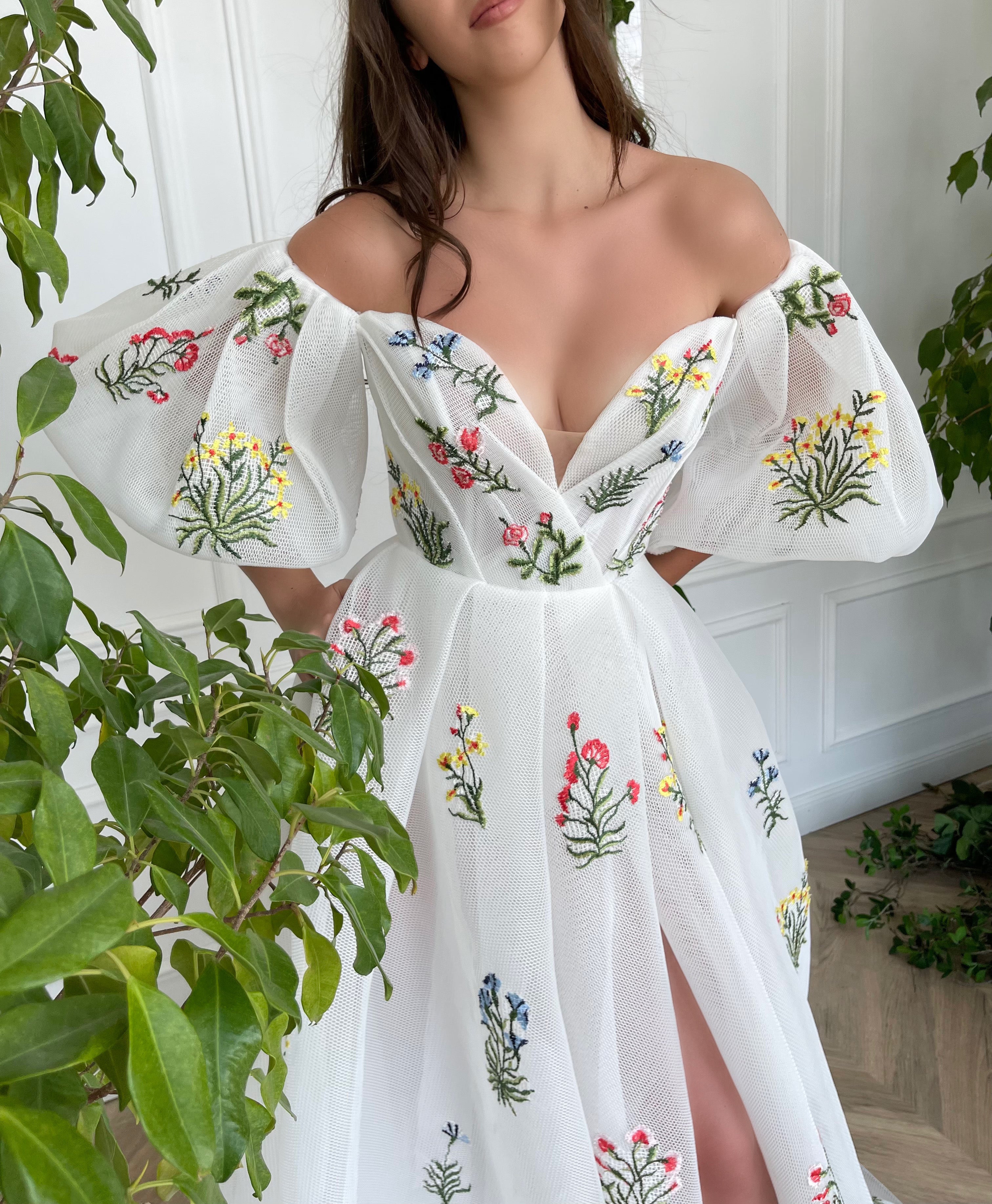 A line white bridal dress with embroidered flowers and off shoulder sleeves