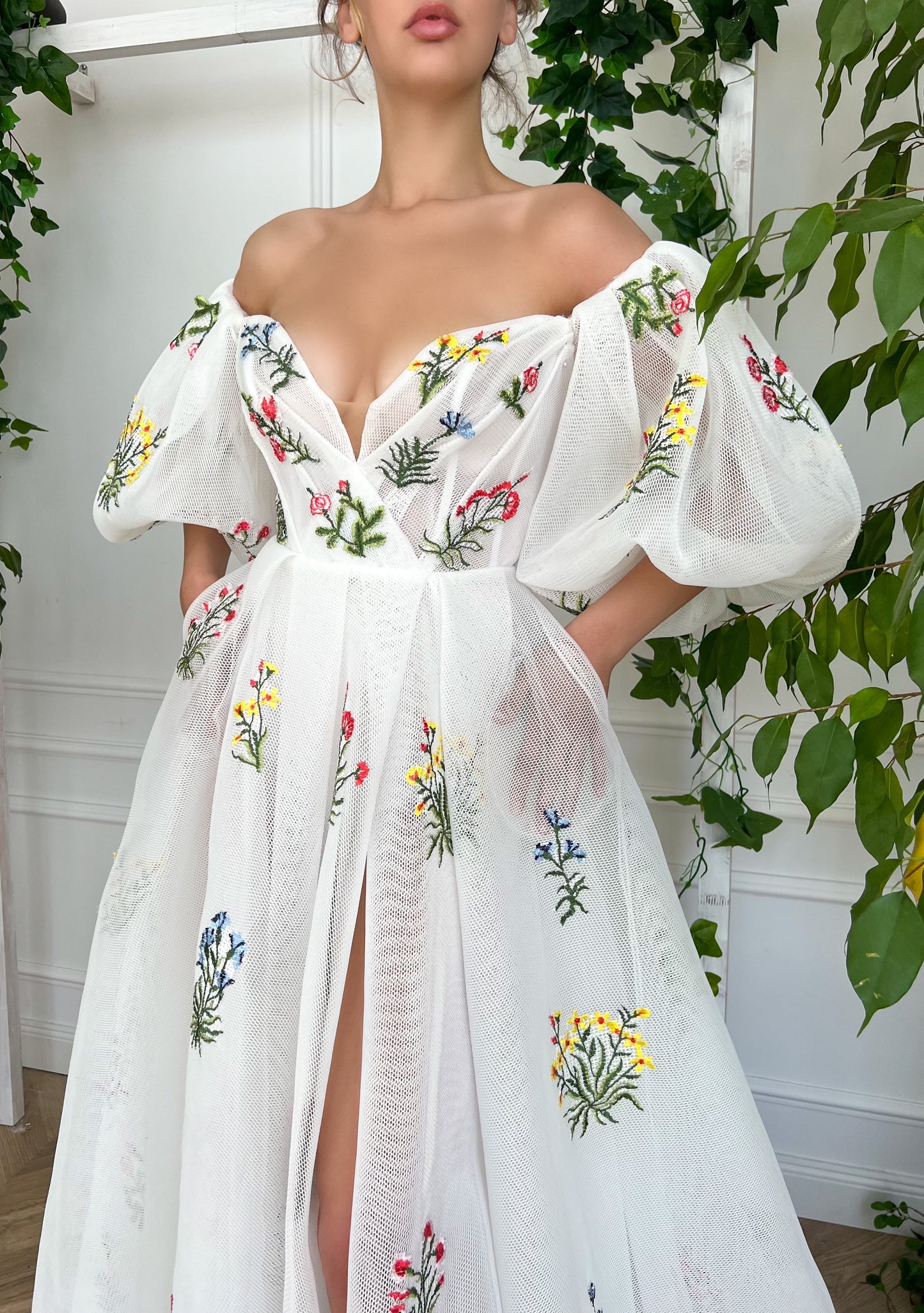 A line white bridal dress with embroidered flowers and off shoulder sleeves