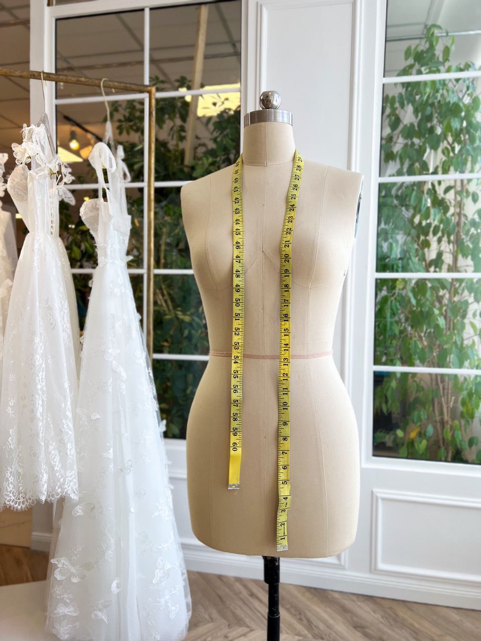 Dress form with measuring tape in the Teuta Matoshi atelier