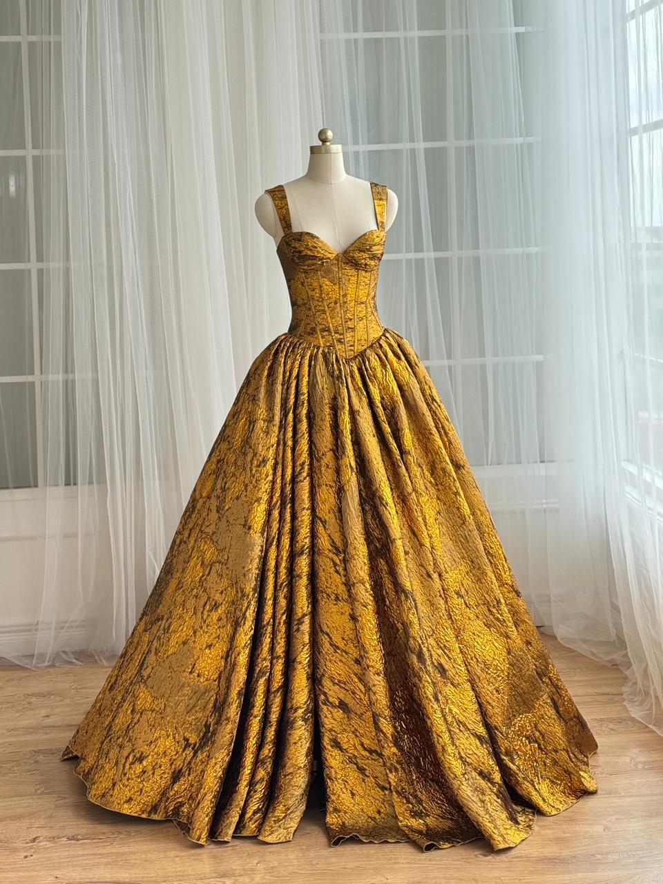 Gold A-Line gown with straps and brocade fabric